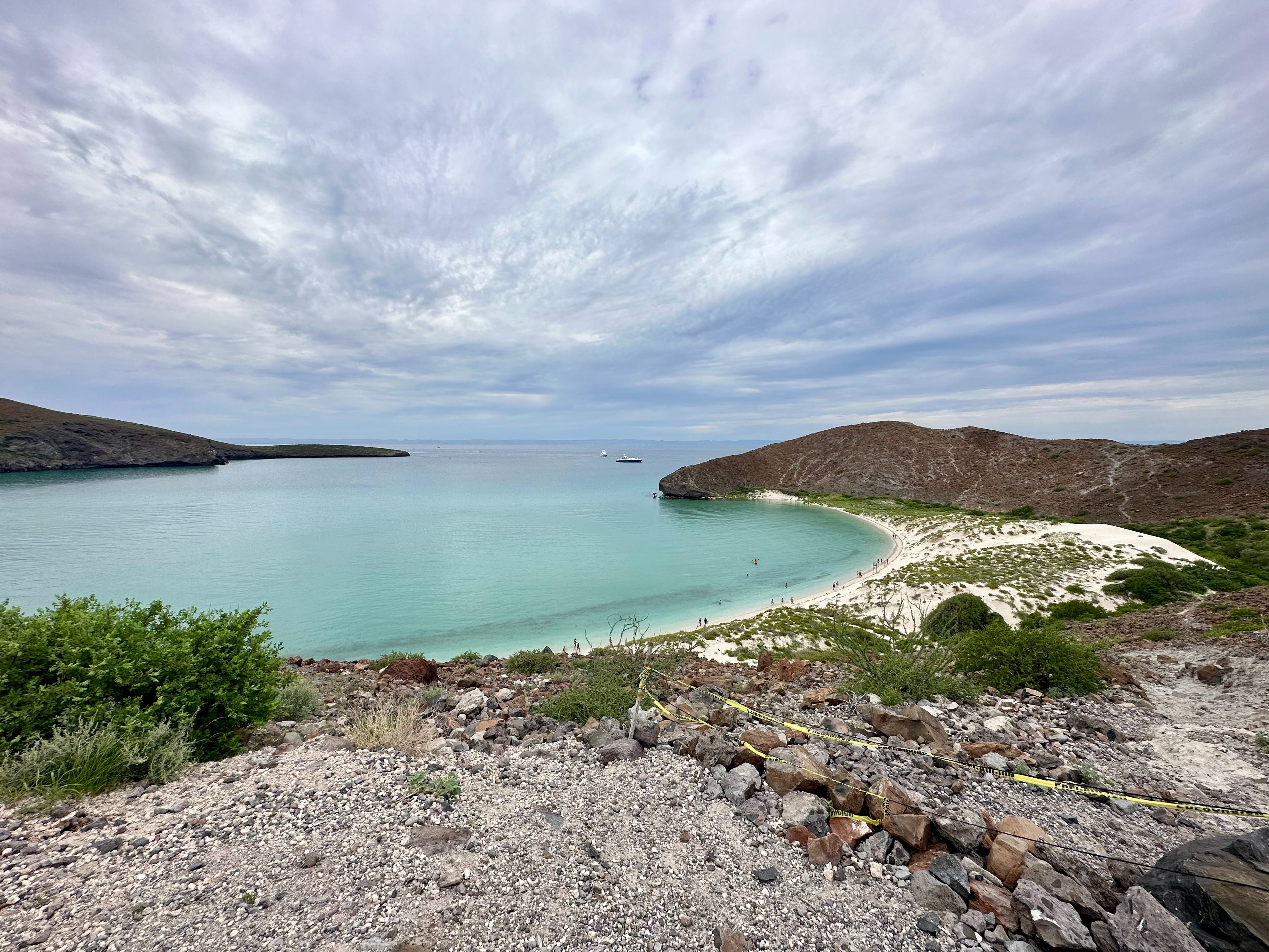 A rocky beach by the water during the daytime
