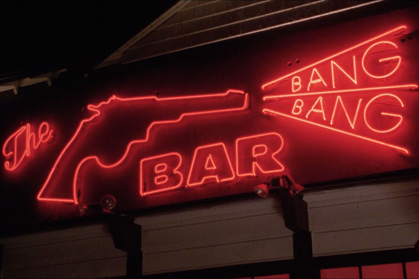 A red, neon sign of The Bang Bang Bar in Twin Peaks.