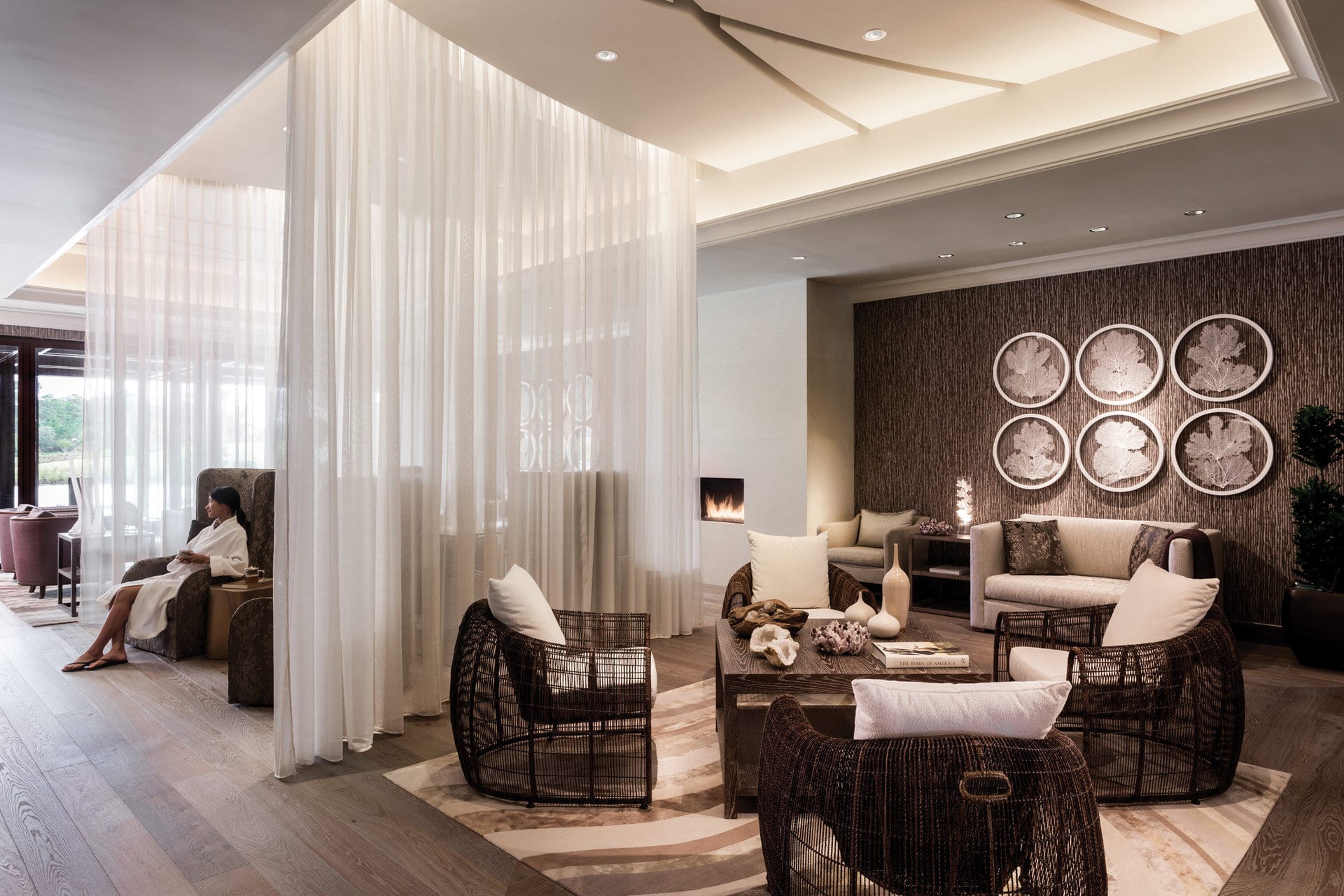 A lavish spa filled with elegant draperies, comfy loungers and sleek but relaxing decor