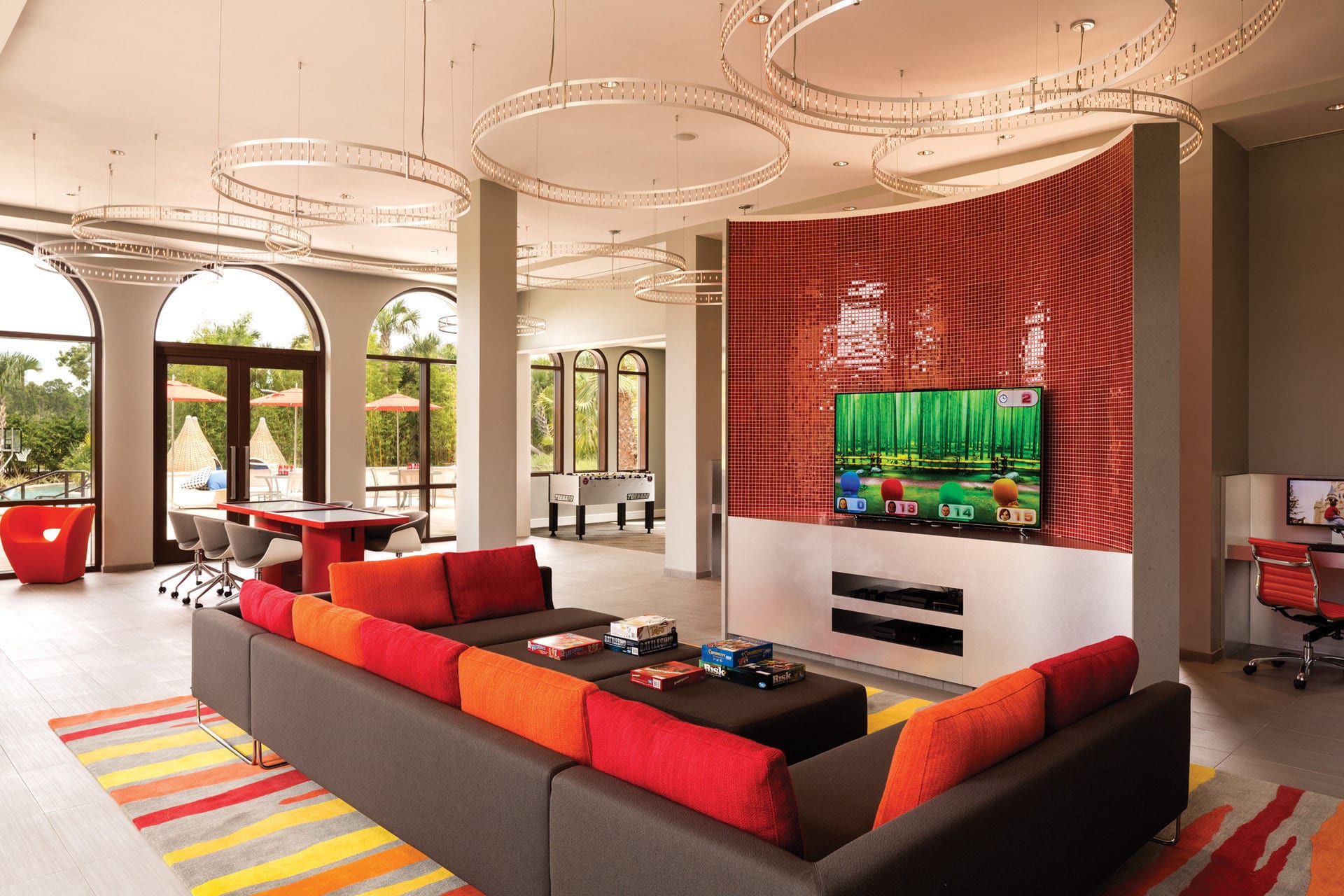 A specialty suite's common space hosts comfy furniture and an array of video games, board games and more family-friendly activities