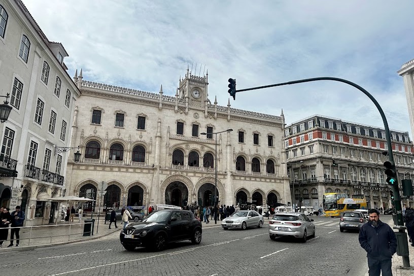 A view of historic buildings next to a busy avenue in the city
