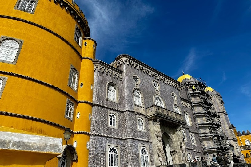 The unique exterior of Pena Palace in Sintra with its bright yellow and gray facade