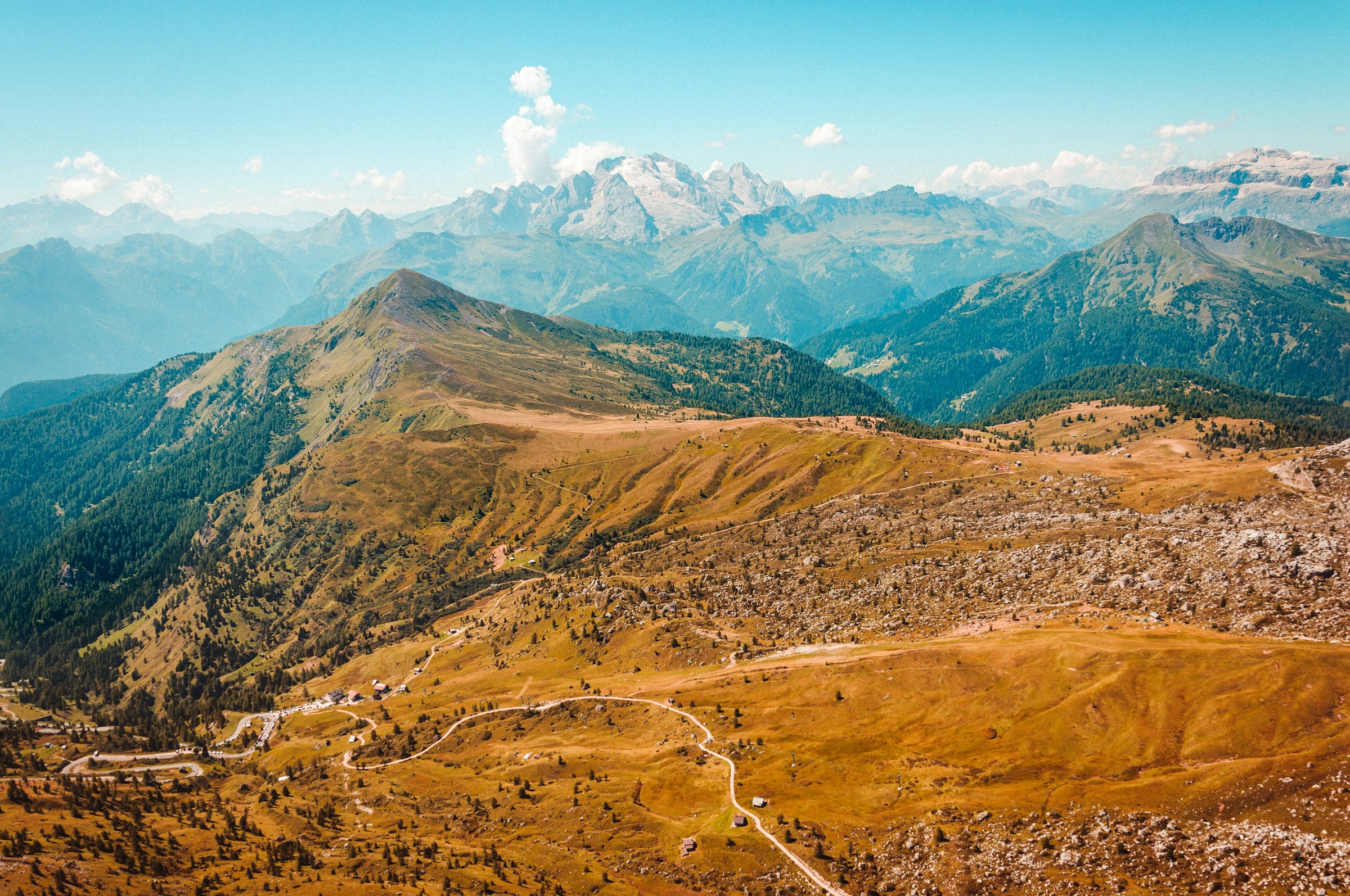 A stunning view of the raw and rugged landscape atop the Dolomites on a sunny day.