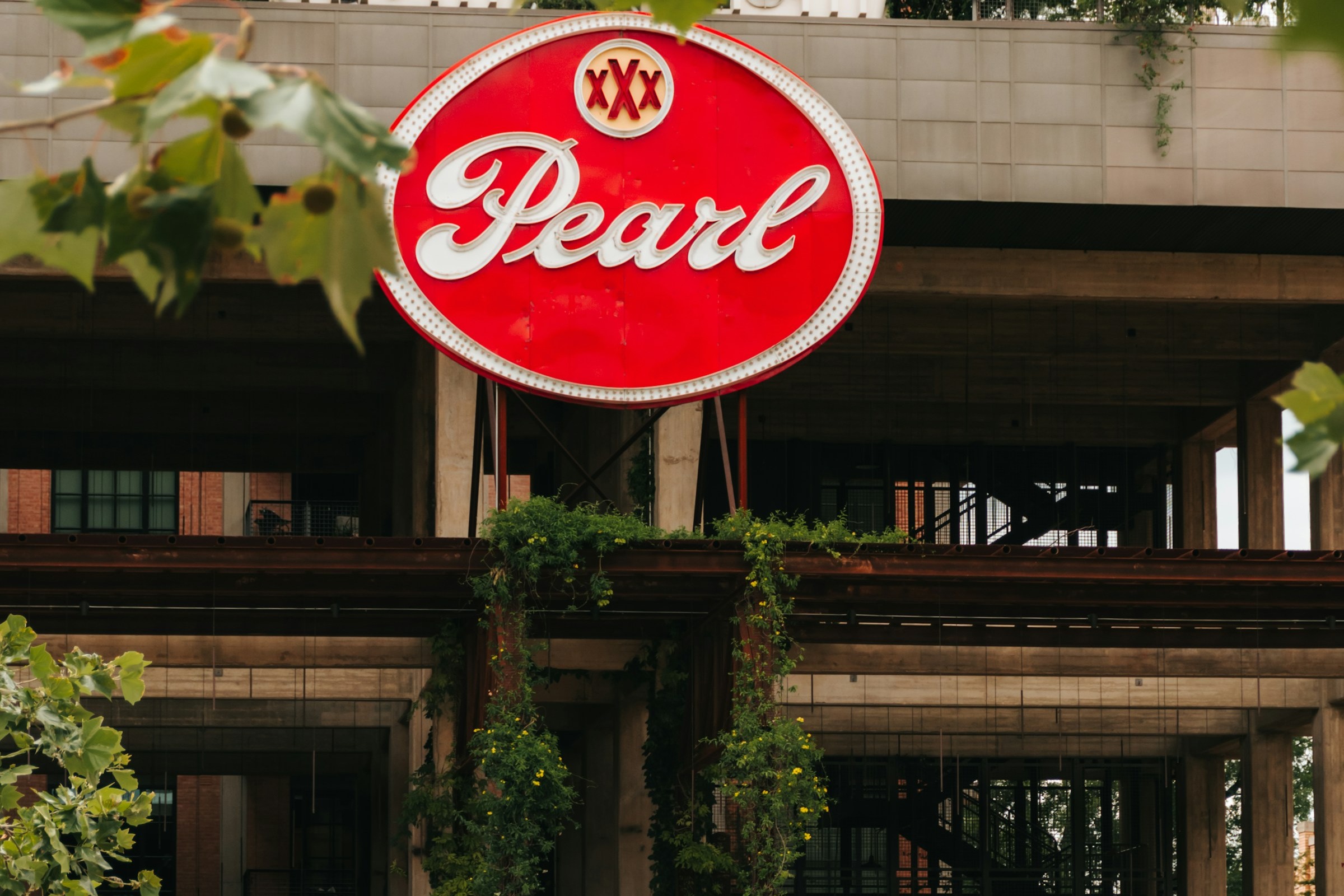Red and white signage of Pearl Brewery.
