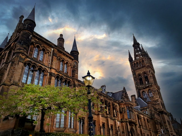 A view of KELVINGROVE ART GALLERY AND MUSEUM, from below, with a dark and ominous sky above it.