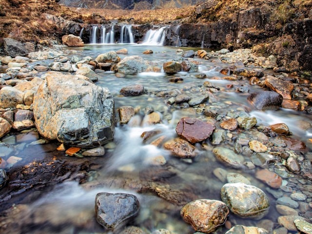 A long-exposure shot of a river trickling its way down a rocky path.