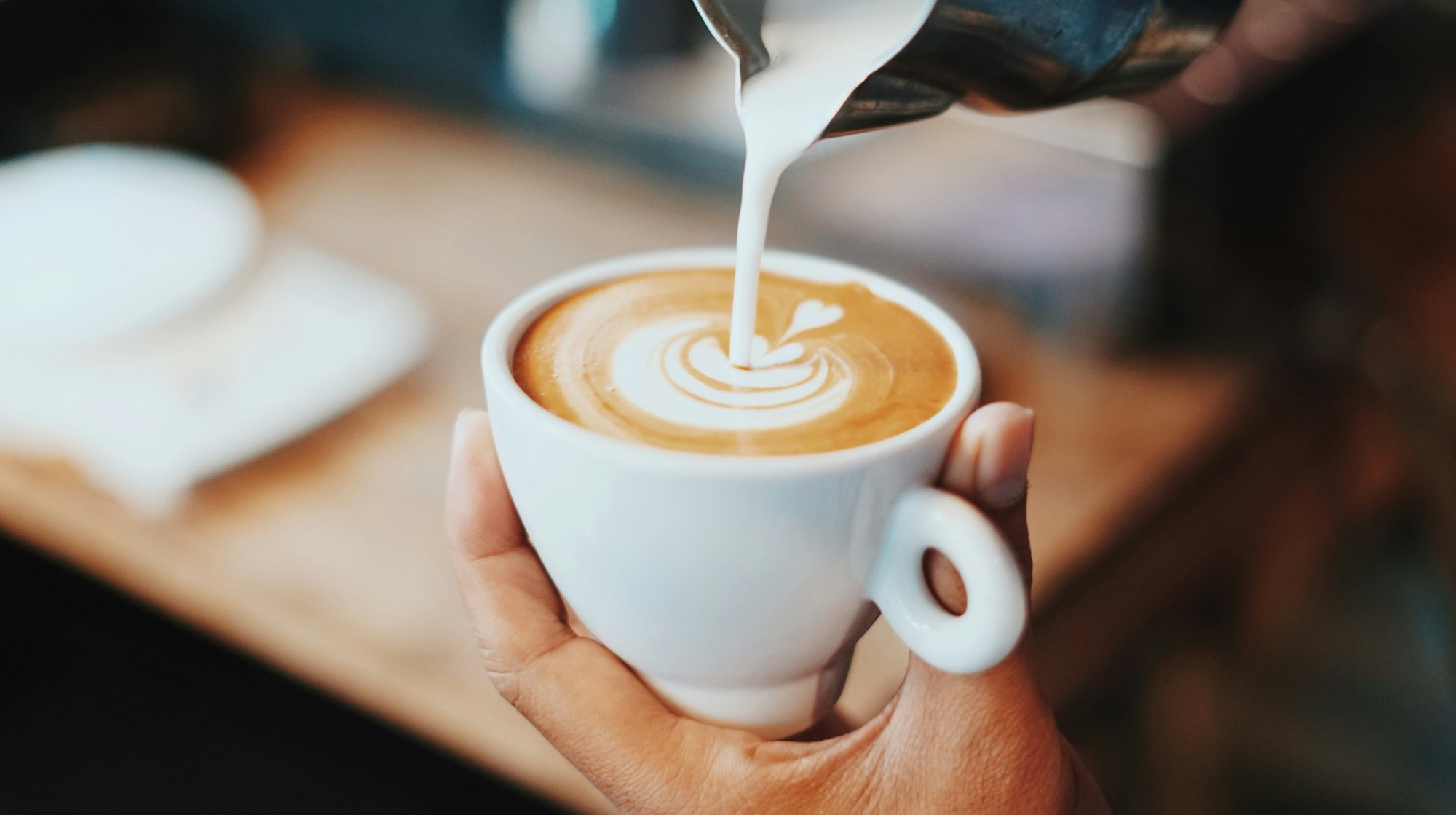 Person making latte art.