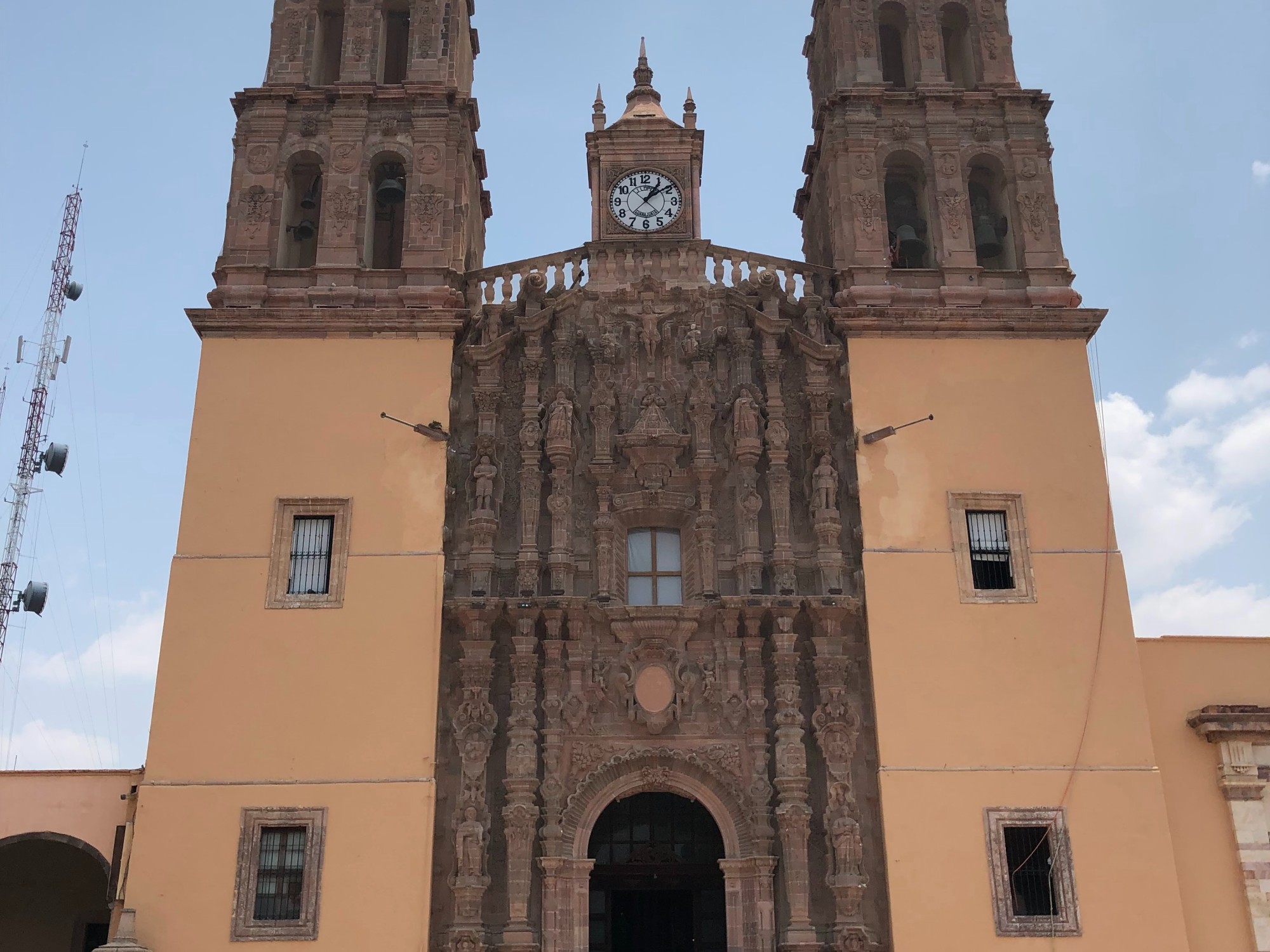 Low-angled view of a tall building with a clock tower in the middle