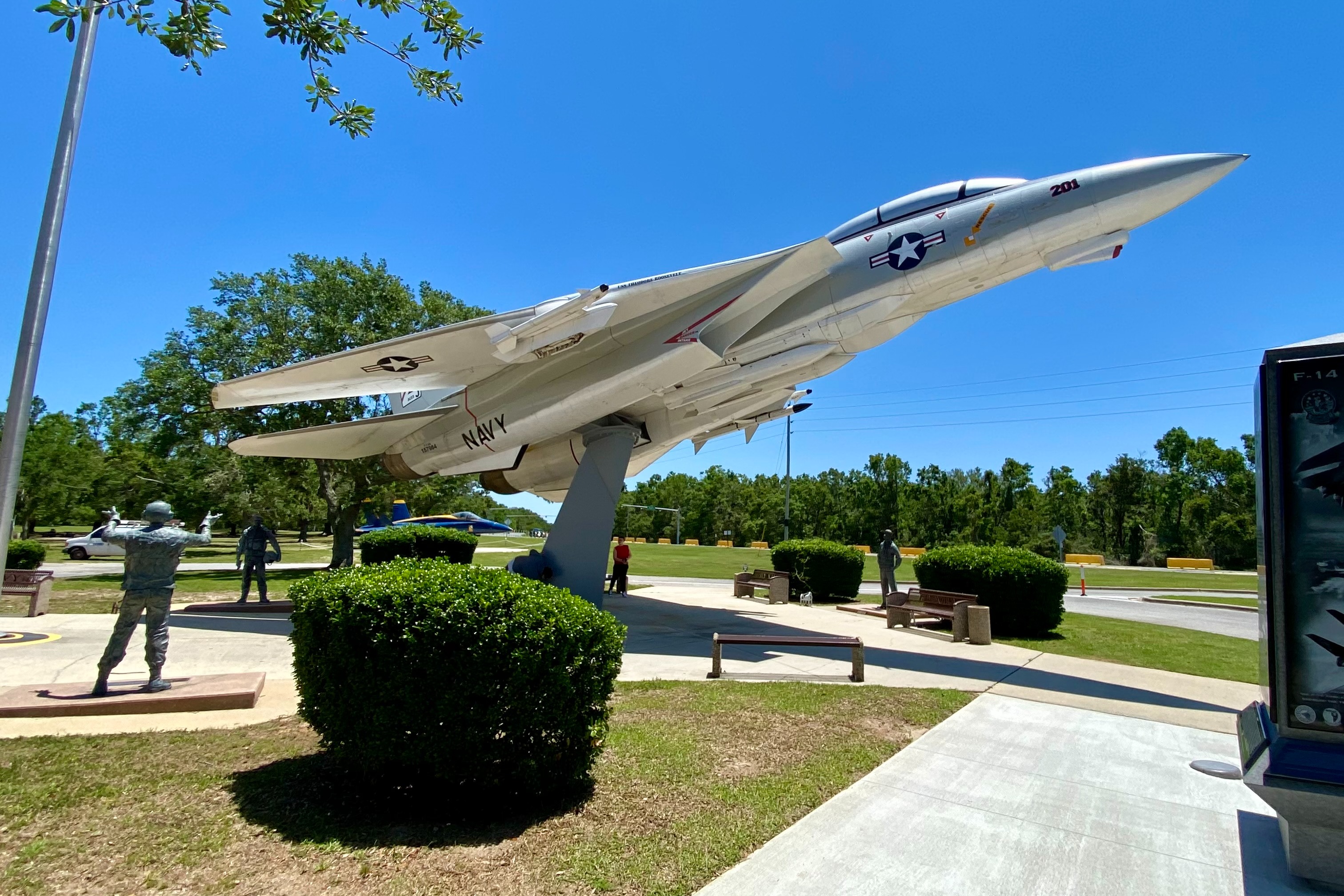 A military plane on display outside during the daytime
