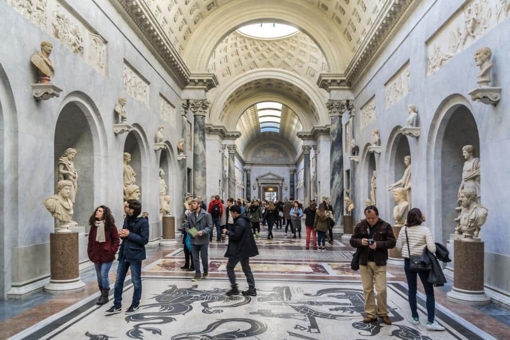 Inside the grand hallway, decorated with stone statues at the Sistine Chapel.