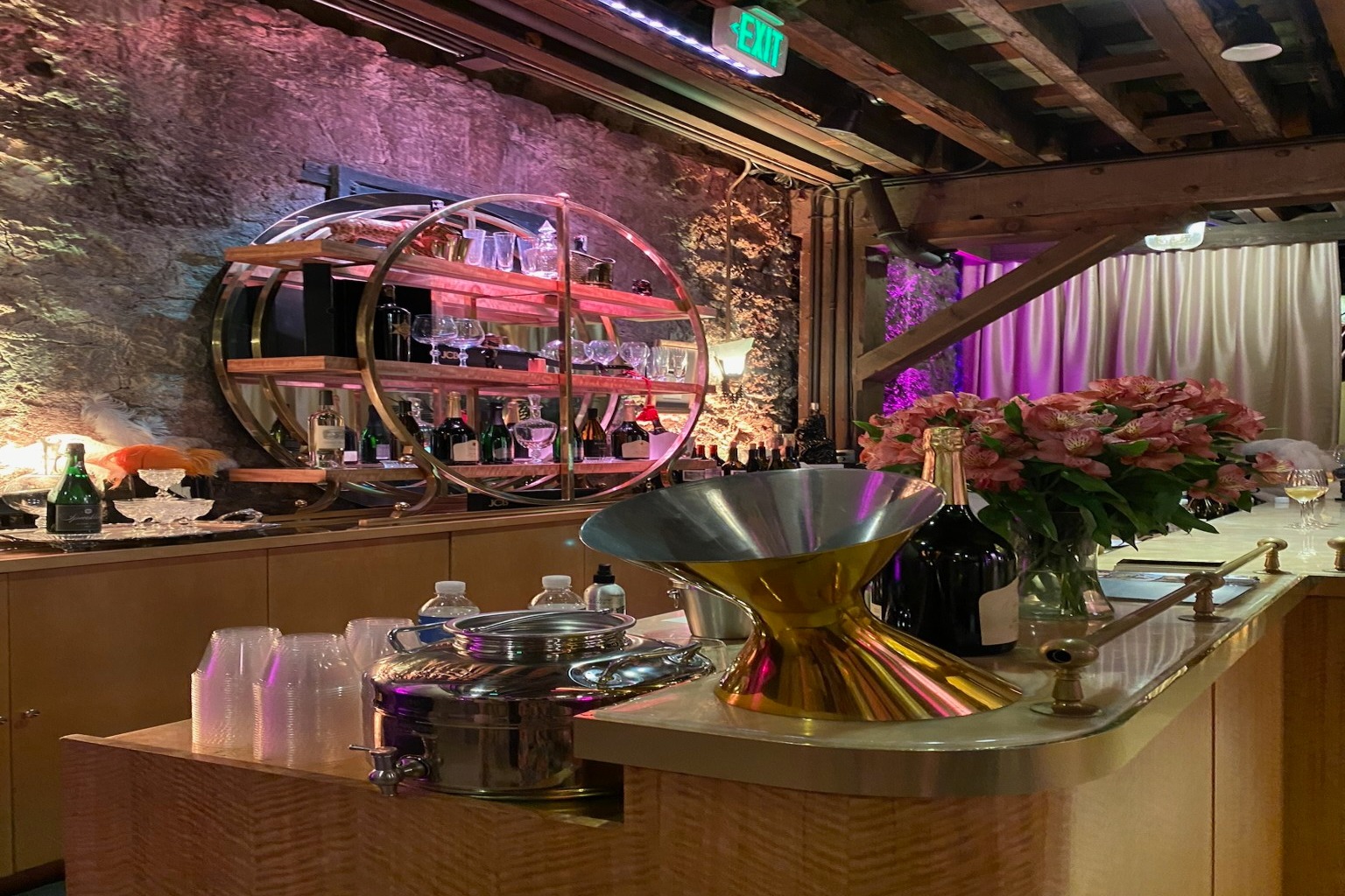 A picture of the glitzy lounge of the winery with a wooden interior and purple lighting around the bar