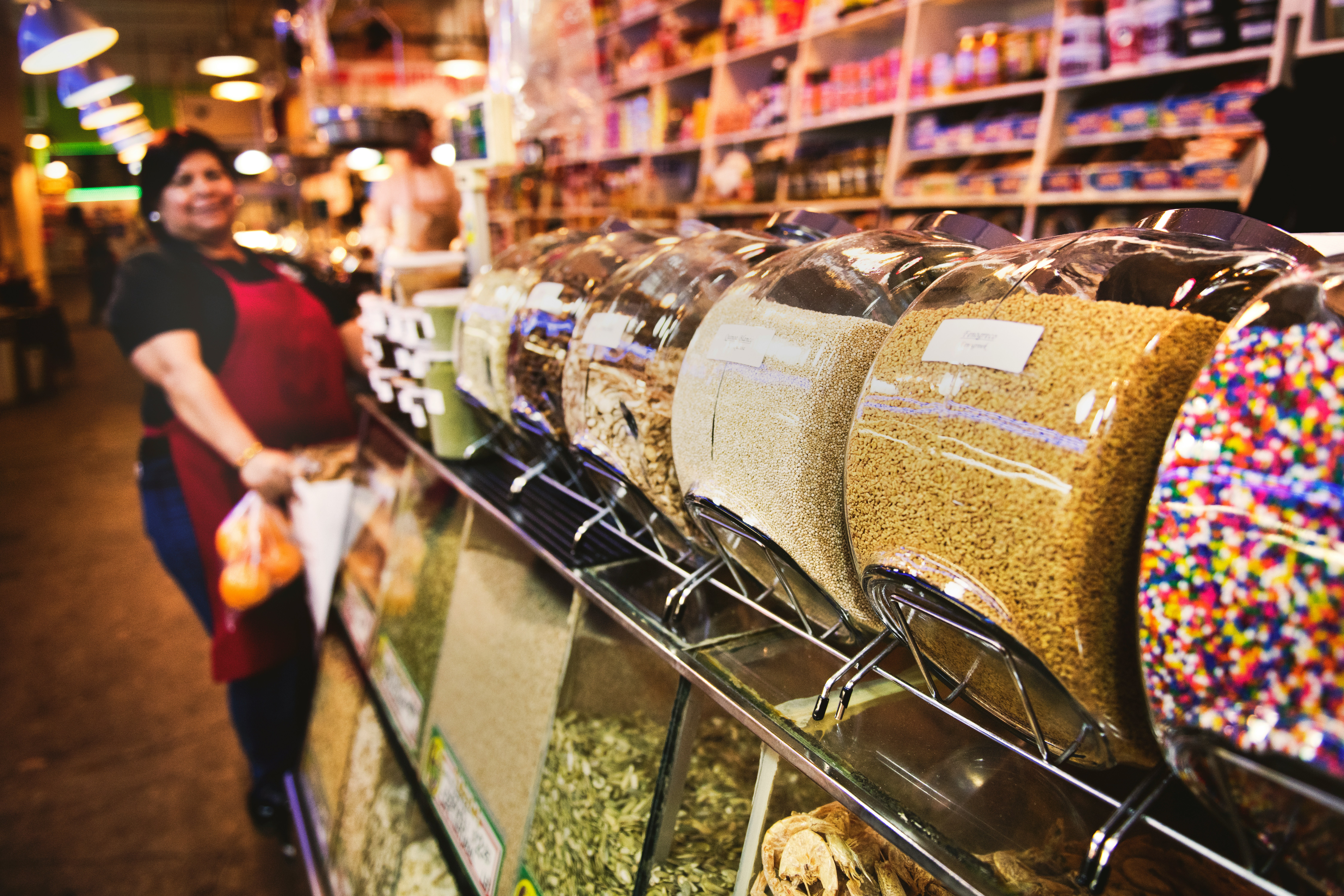 A picture of the Grand Central Market, Los Angeles, with a person standing next to candy jars.