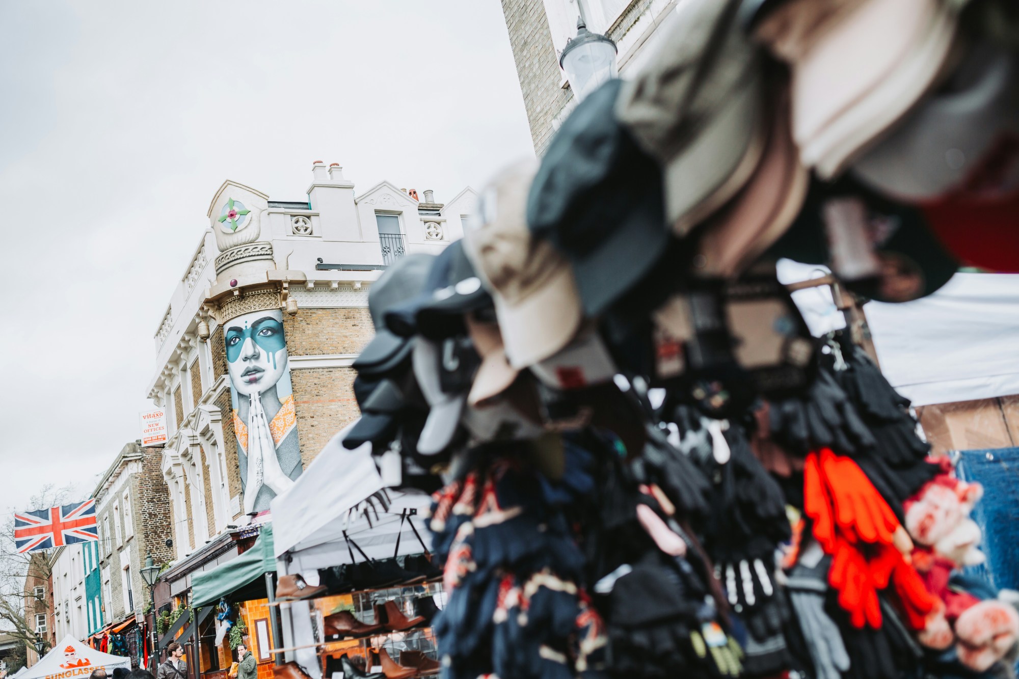 A stall selling hats and gloves at a street market in London