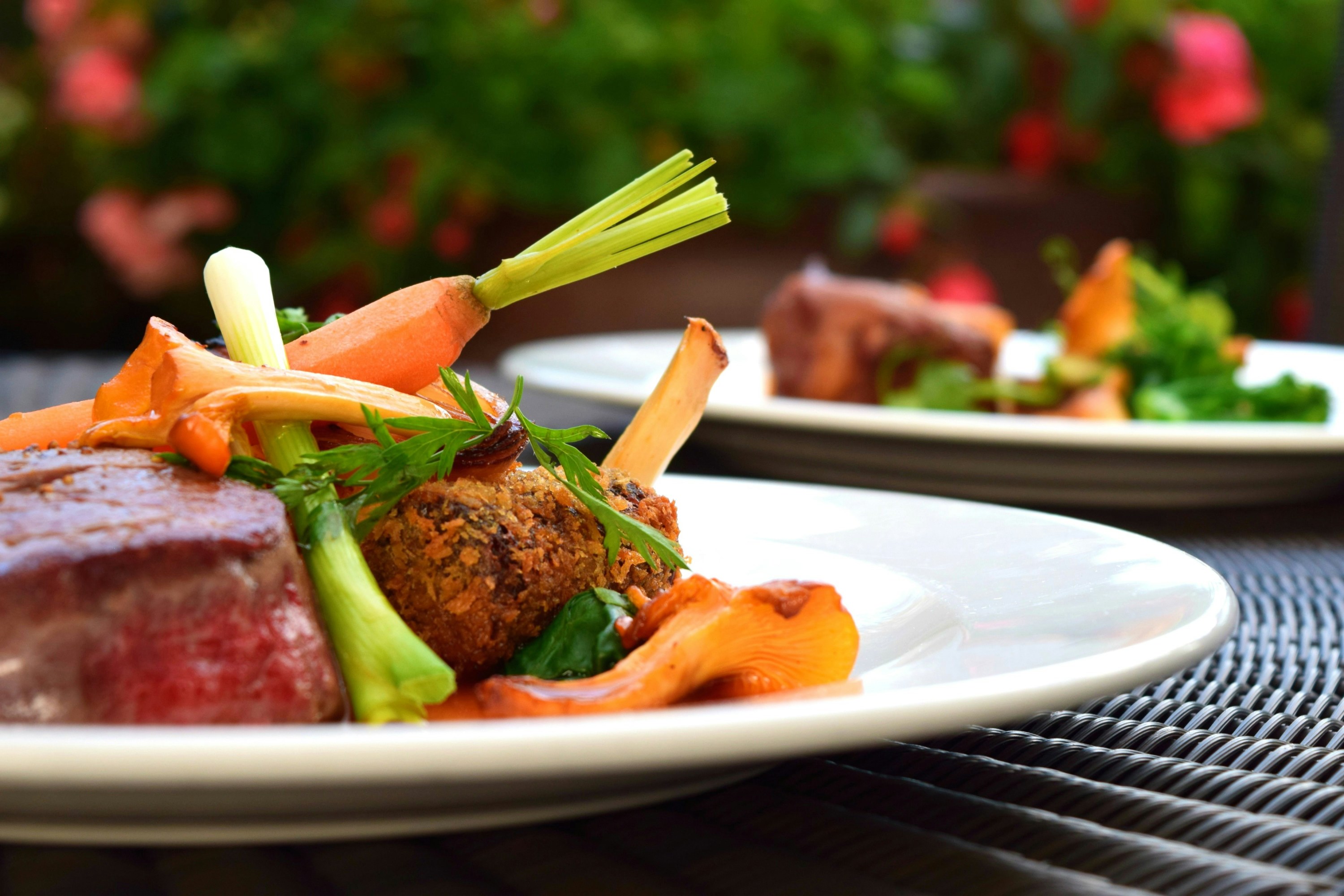 A white plate consisting of meat and veggies.