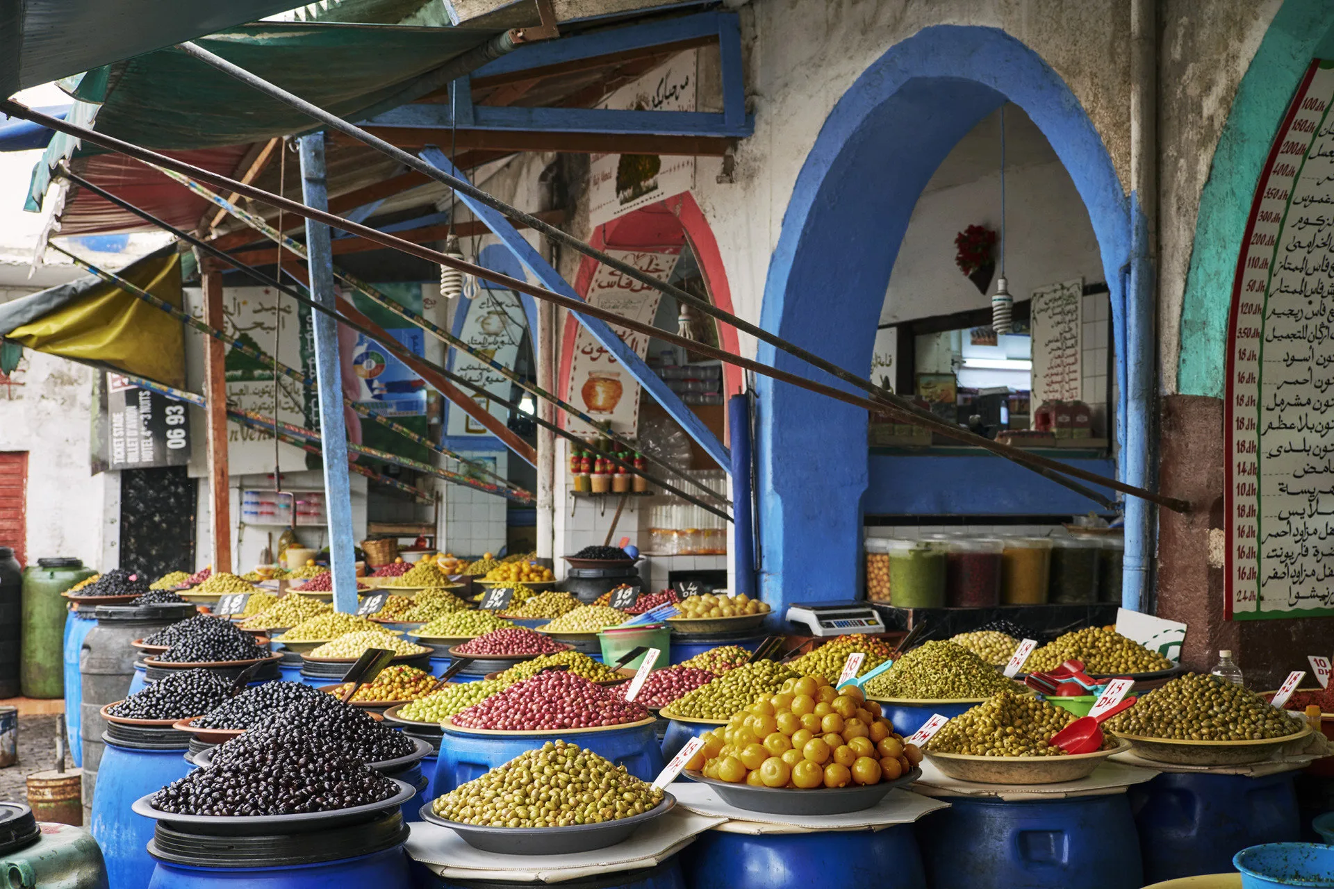 A stall at a Casablanca Medina souk selling a variety of olives, lemons and other fruits