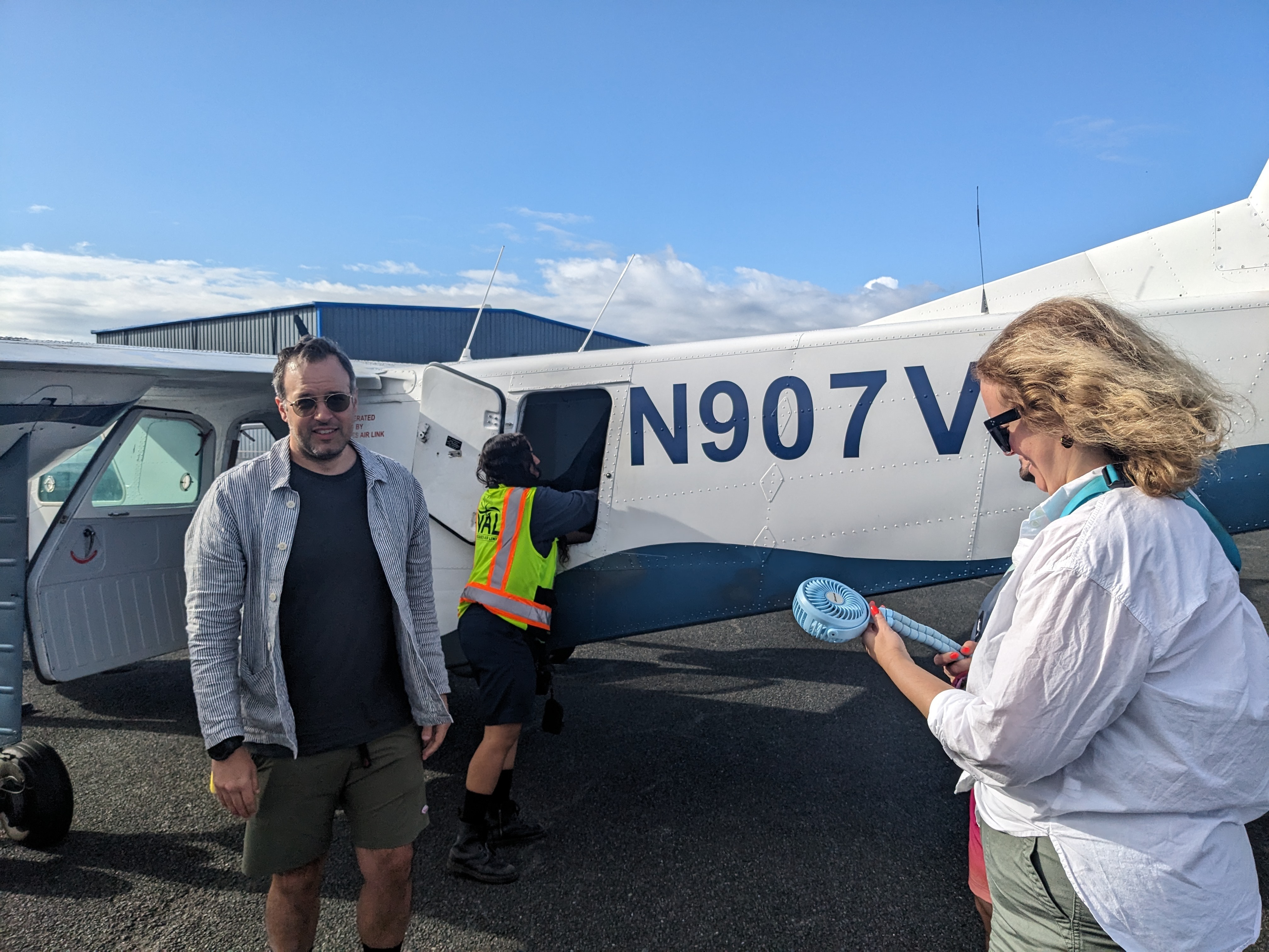 a picture of people boarding a private plane for departure during the daytime.