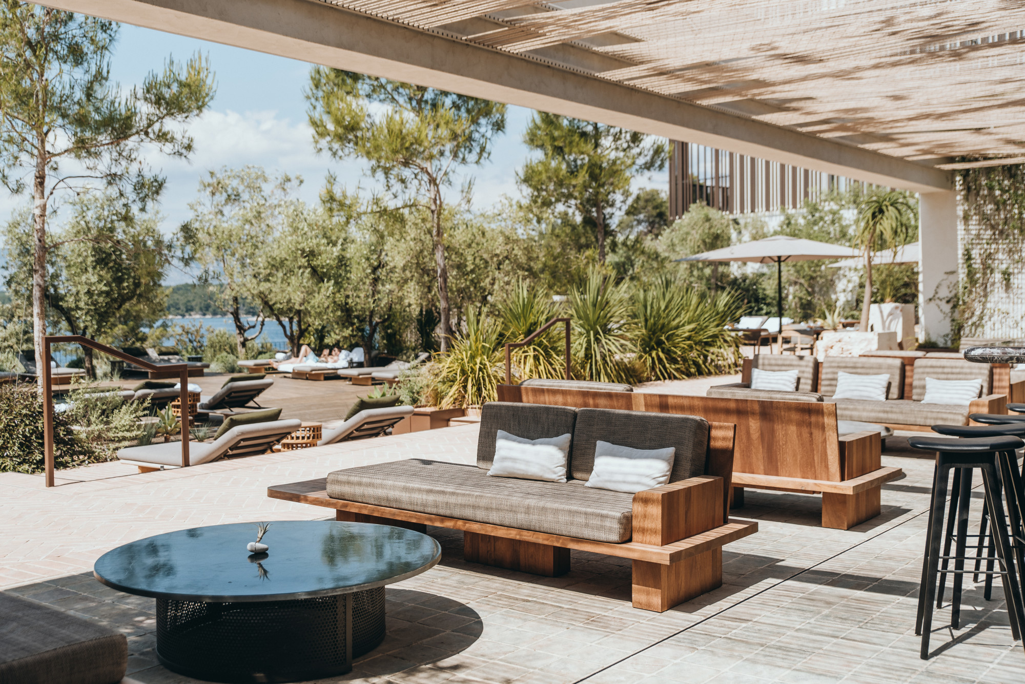 tables and chairs on a sunny pool deck