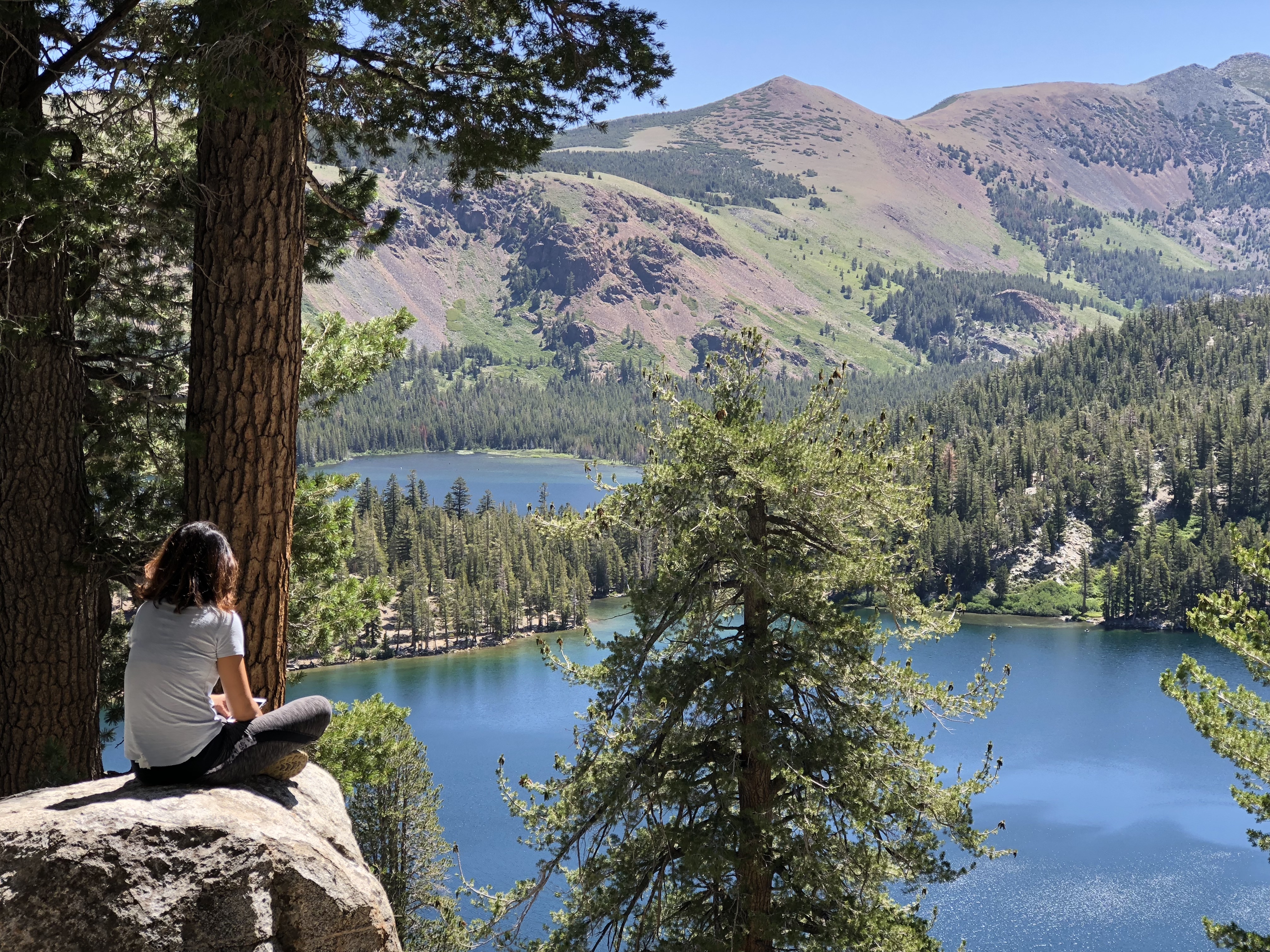 Travel advisor Carol sitting on a rock looking at the serene views of Mammoth Lakes