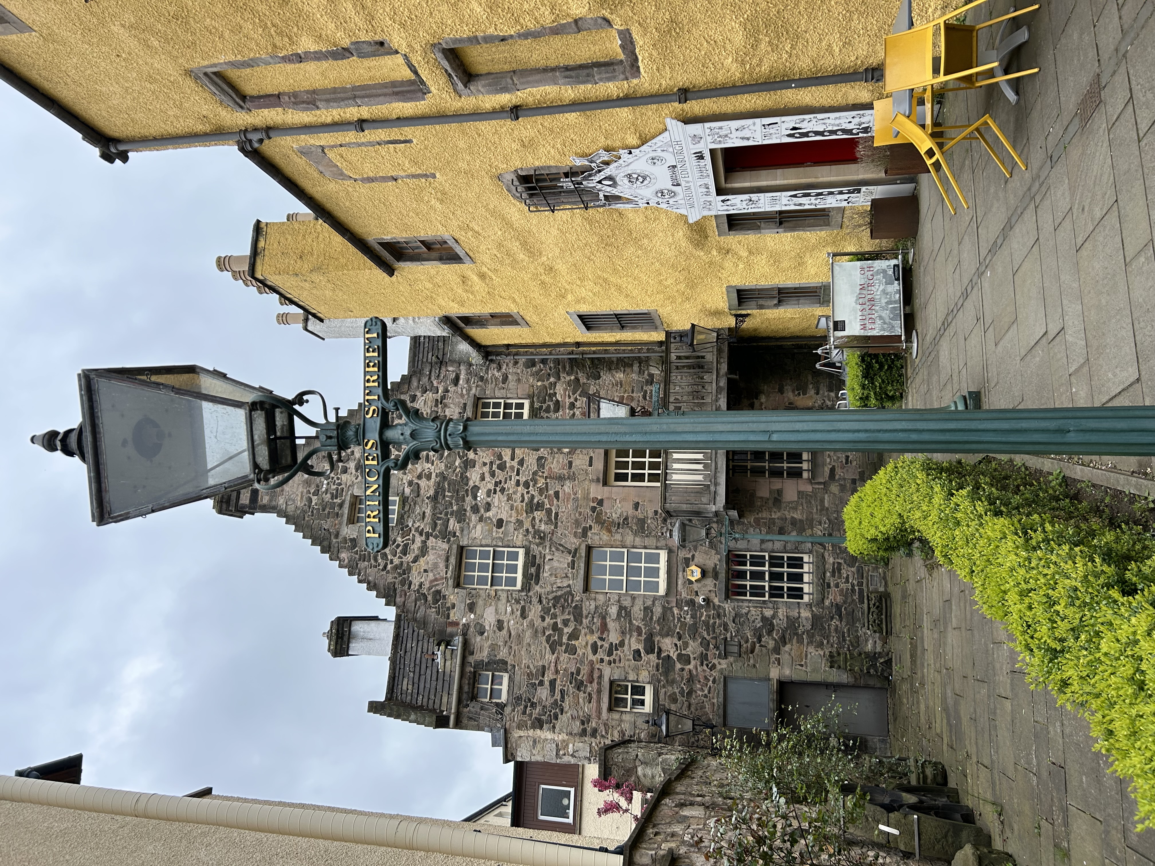 View of small street with old stone and yellow buildings in Edinburgh, Scotland