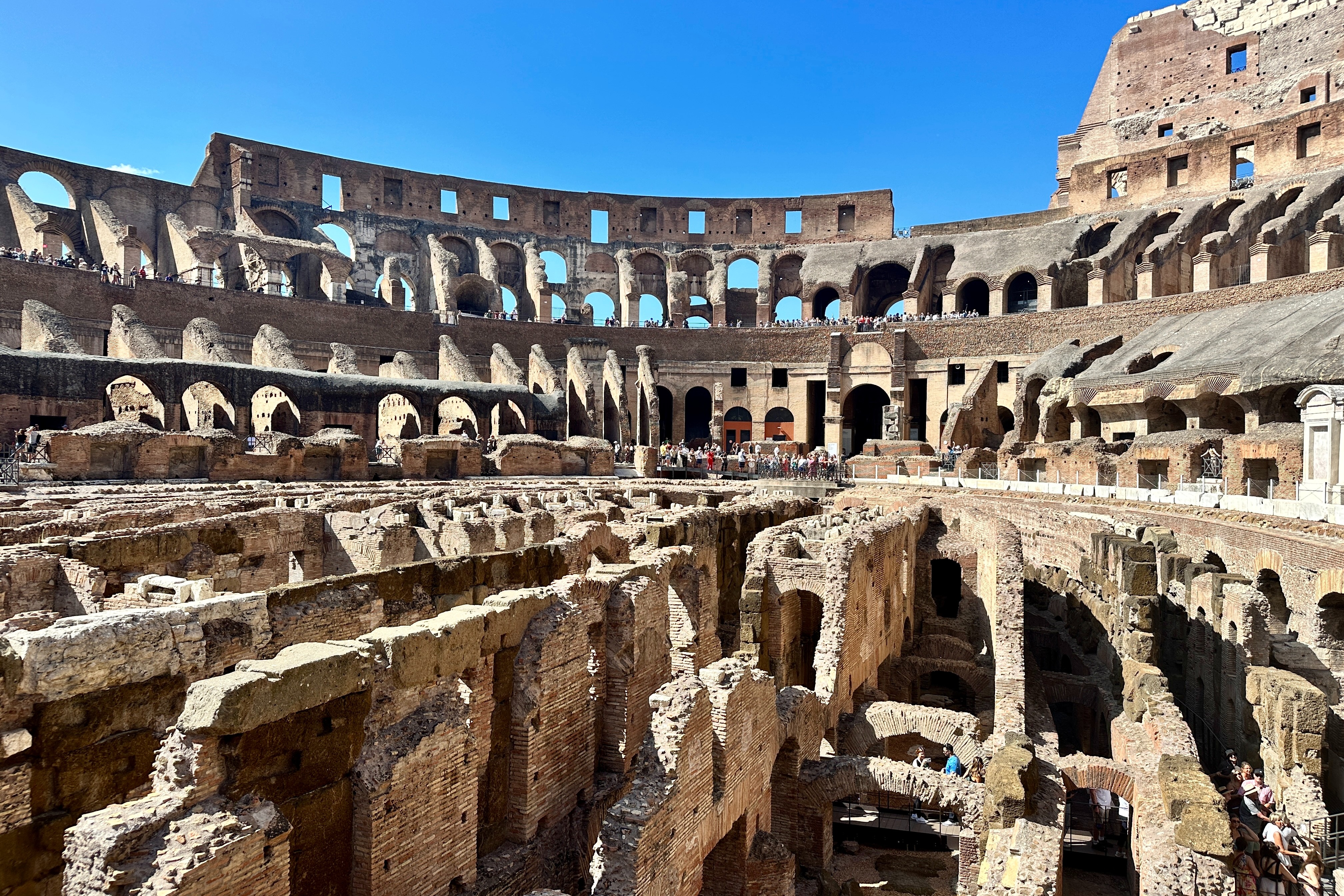 A far view of inside the Colosseum during the daytime.