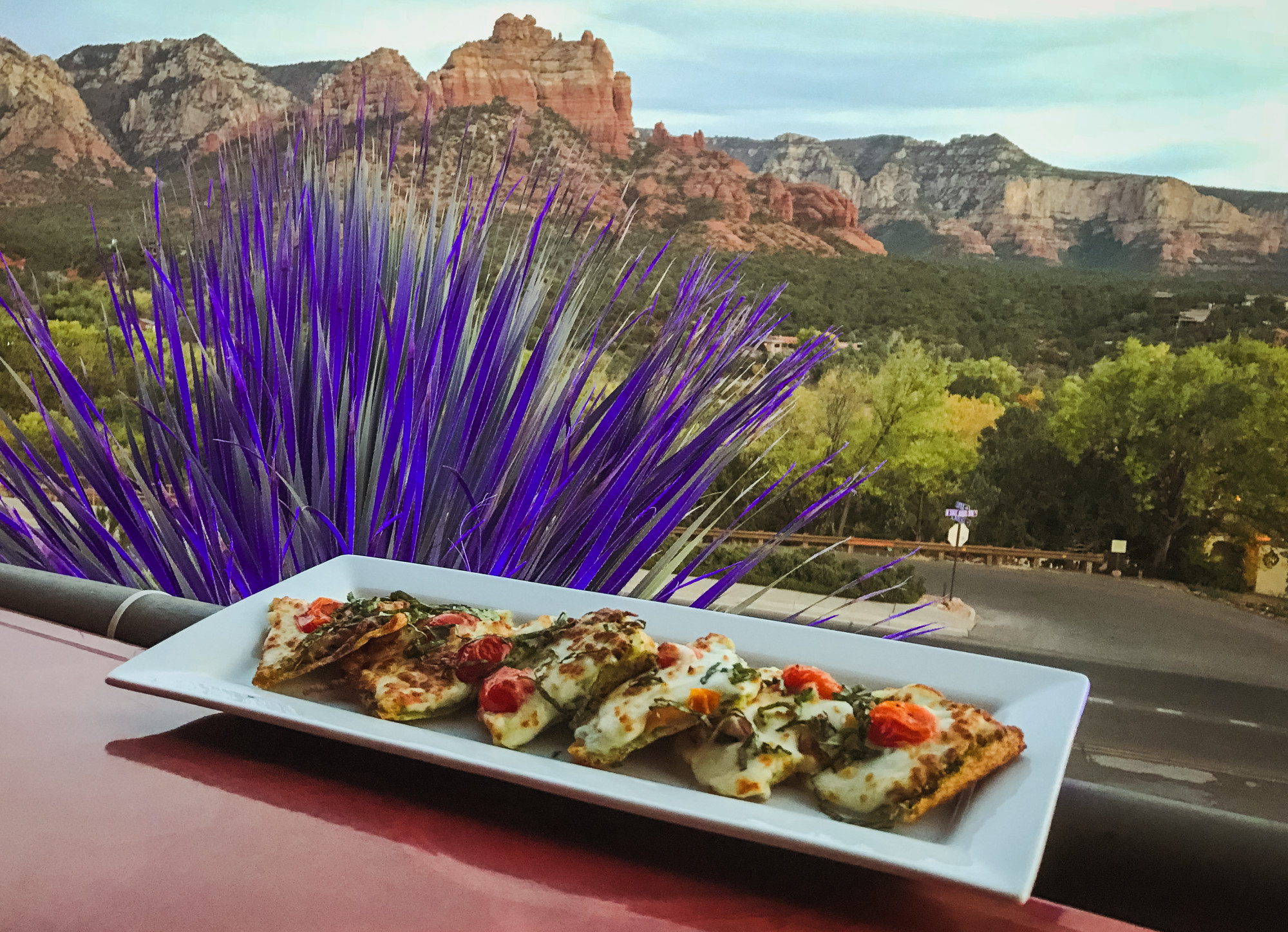 A plate of food on an outdoor table during the daytime