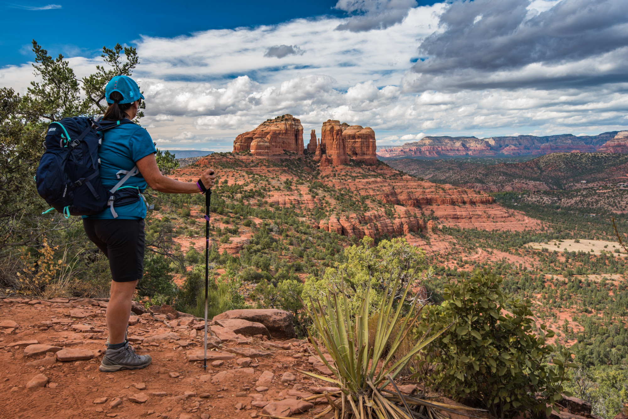 A person on a hiking trail in the desert during the daytime