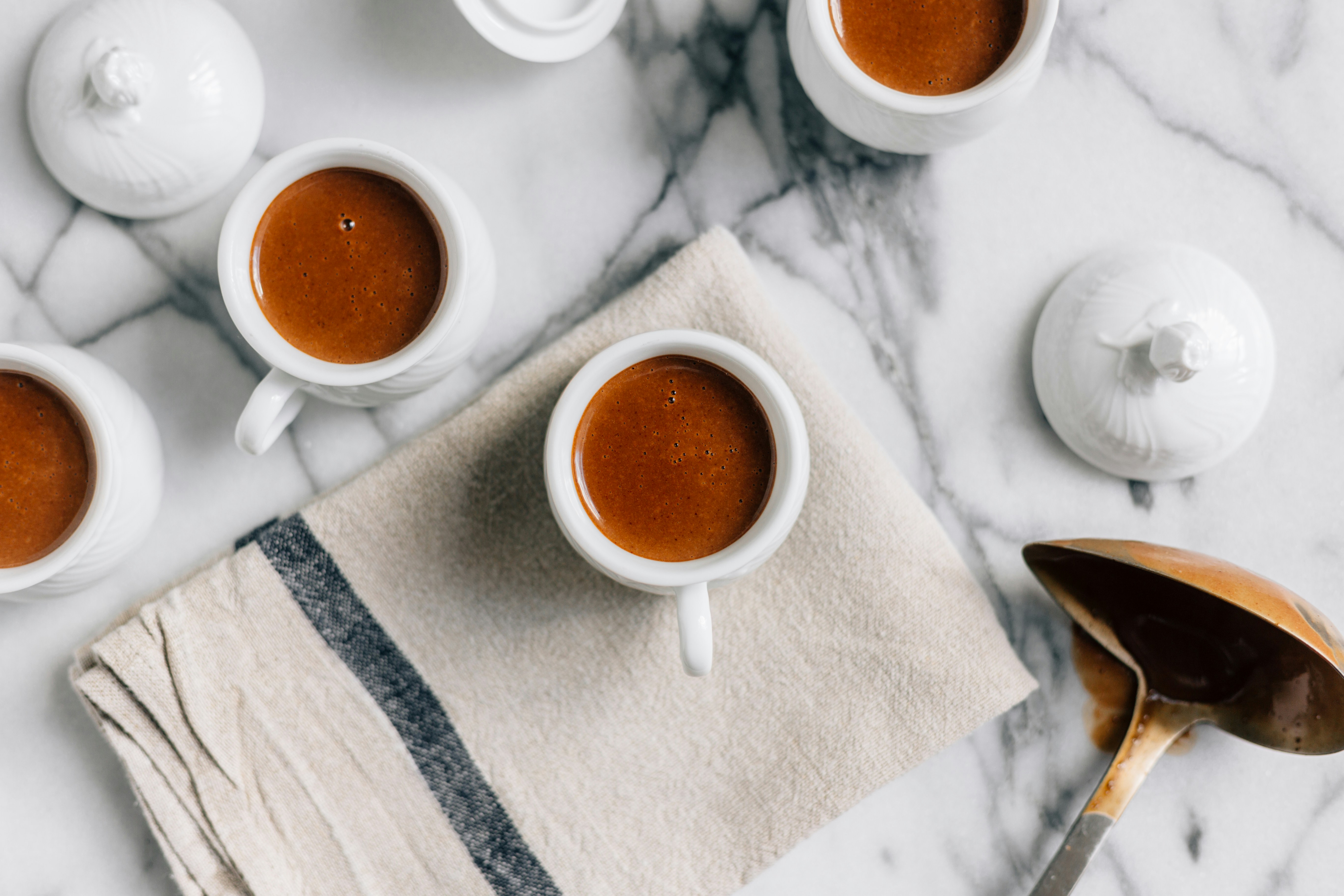 Cups of hot chocolate on a marble table.