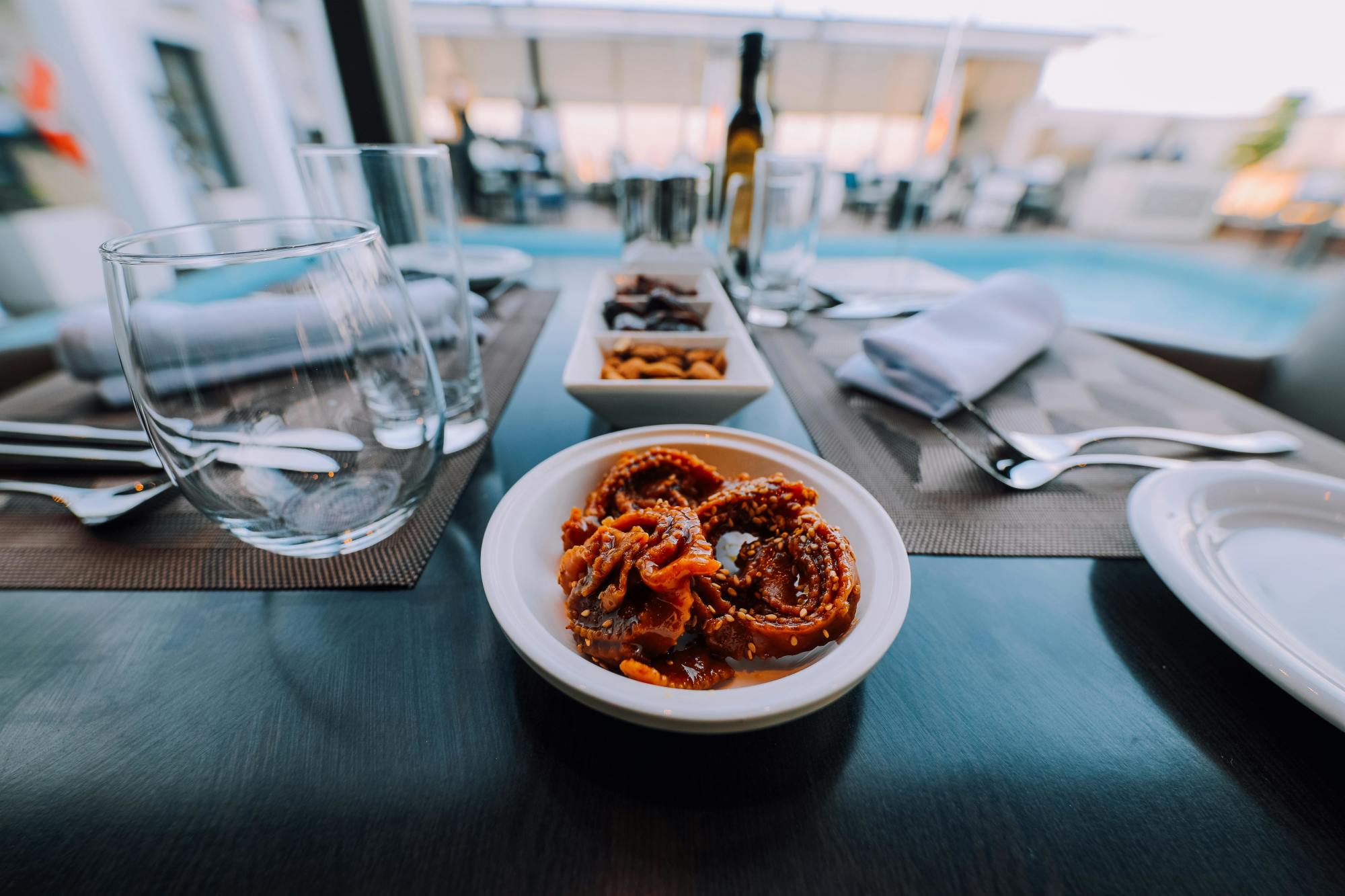 A small bowl of Moroccan Chebakia plated in a formal setting
