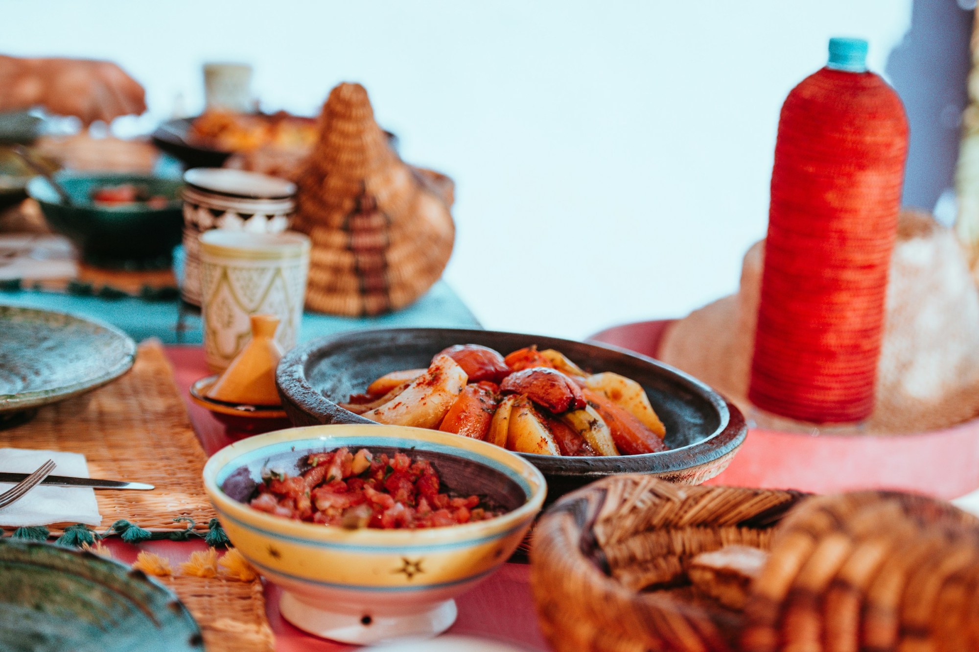 A variety of Moroccan side dishes centered around a vegetable tagine