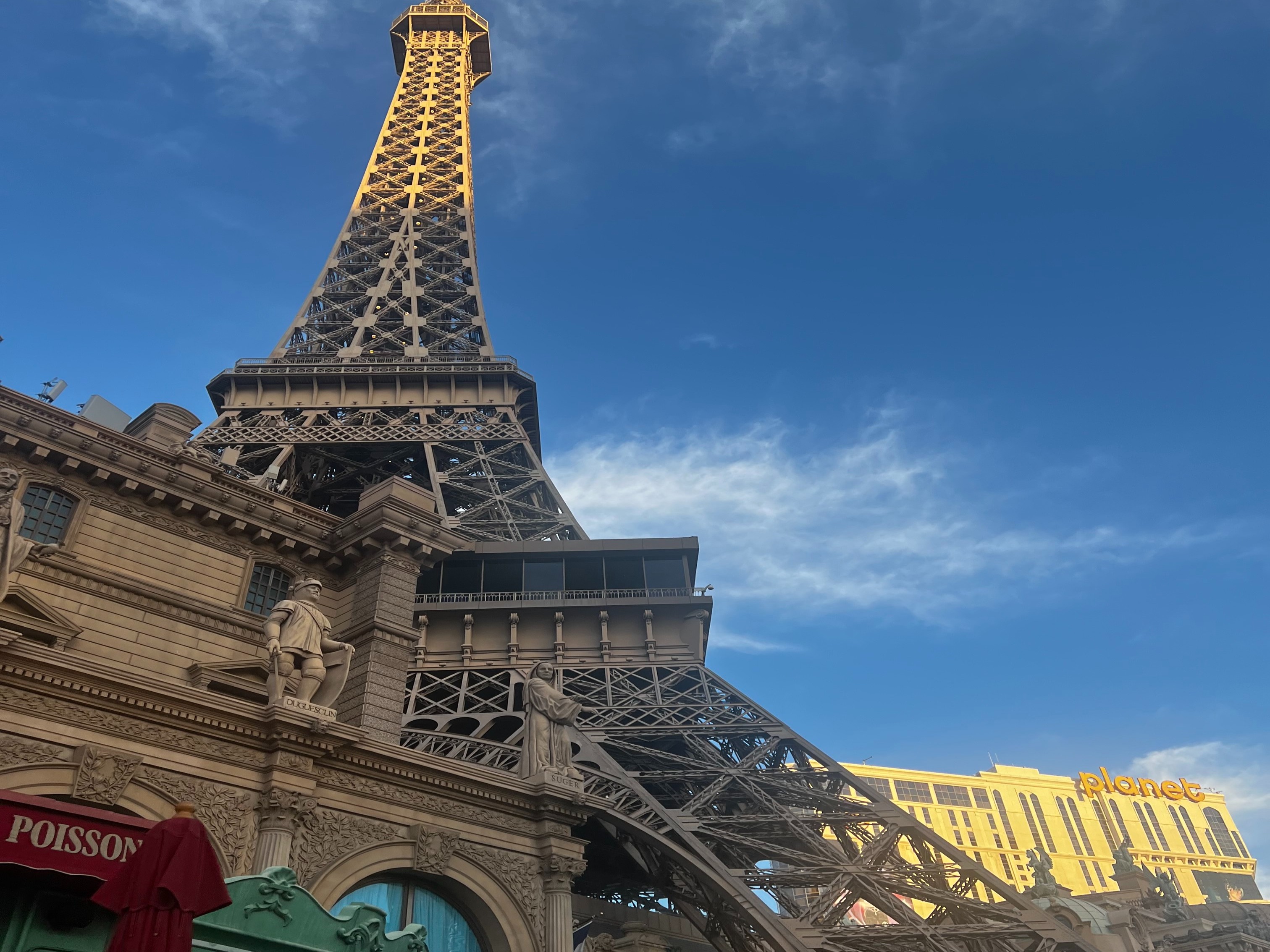 A low-angled shot of a building that looks like the Eiffel Tower during the daytime.