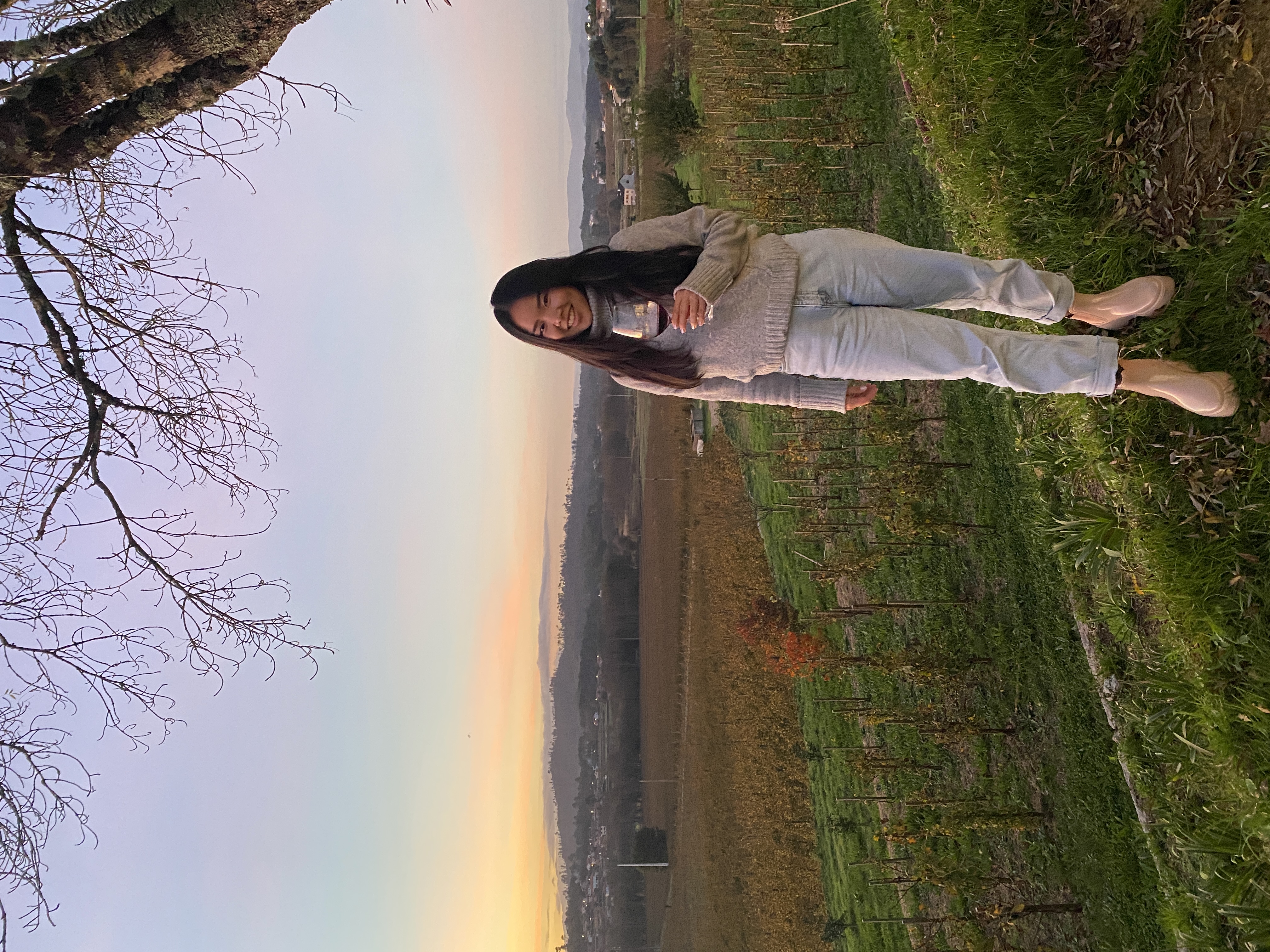 Picture of Candy with a glass in hand at vineyard