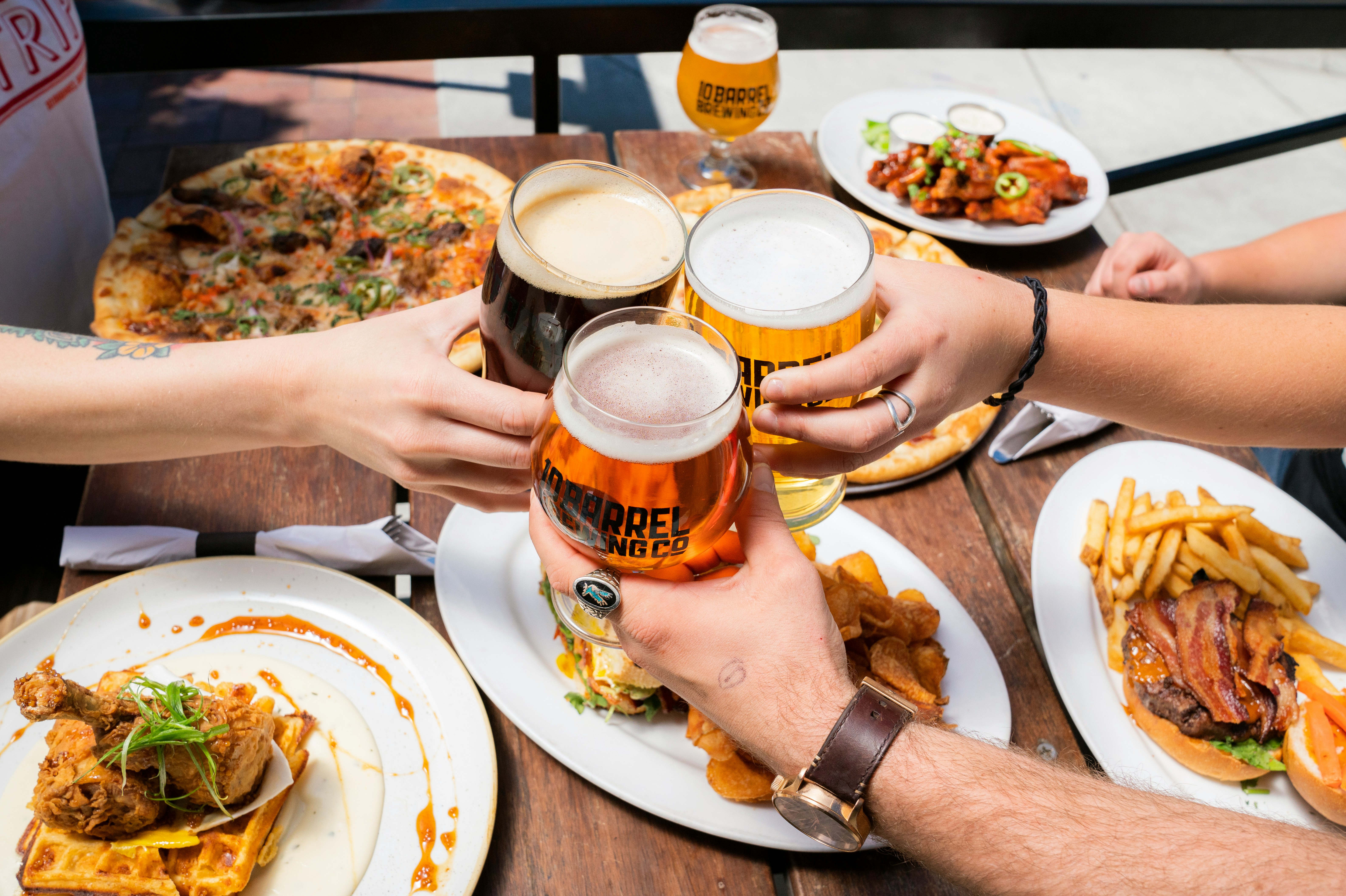 A picture of people at a restaurant, having a toast.