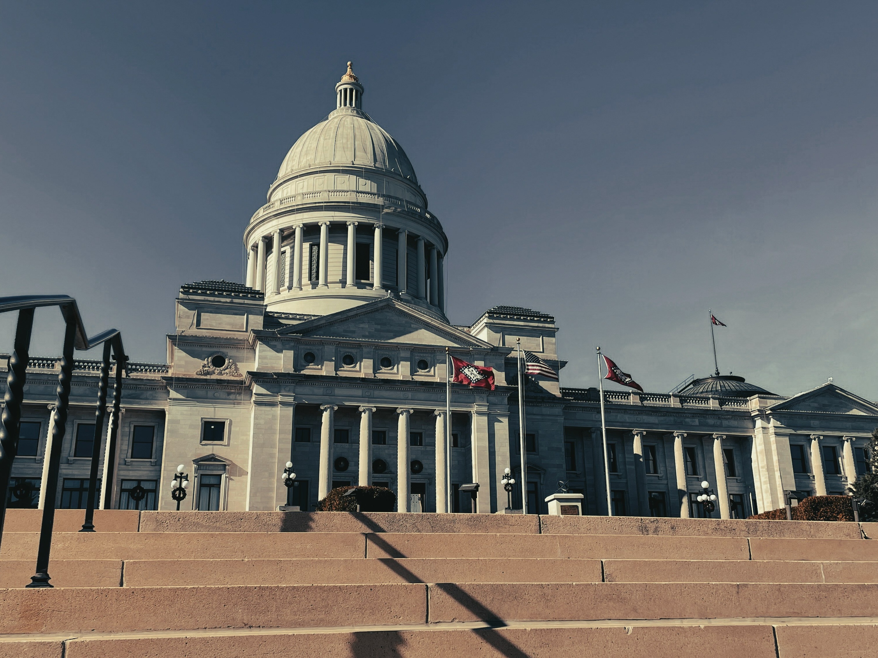 A picture of a large white-colored building with steps leading up to it.