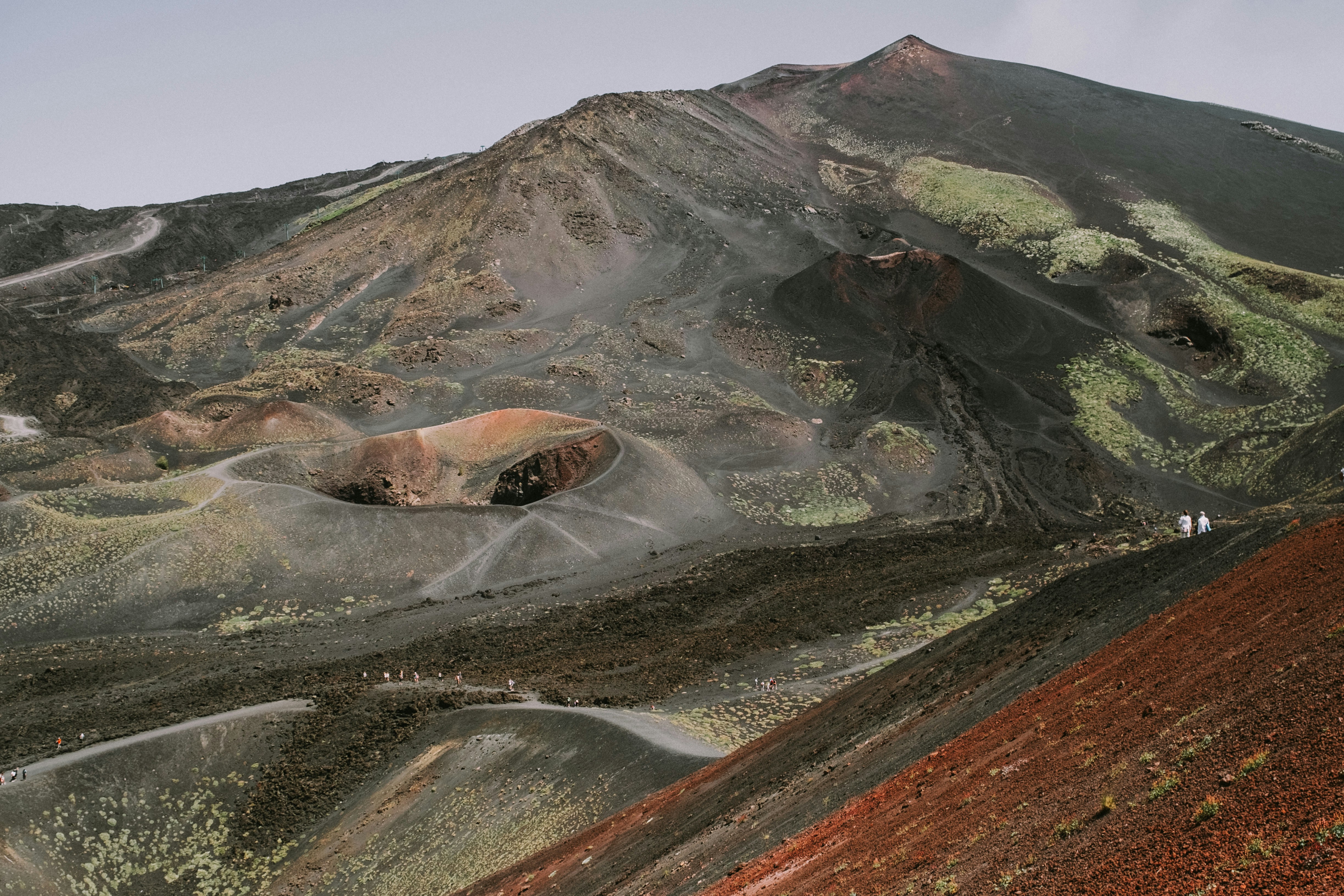 A picture of a brown and gray mountain under the blue sky.
