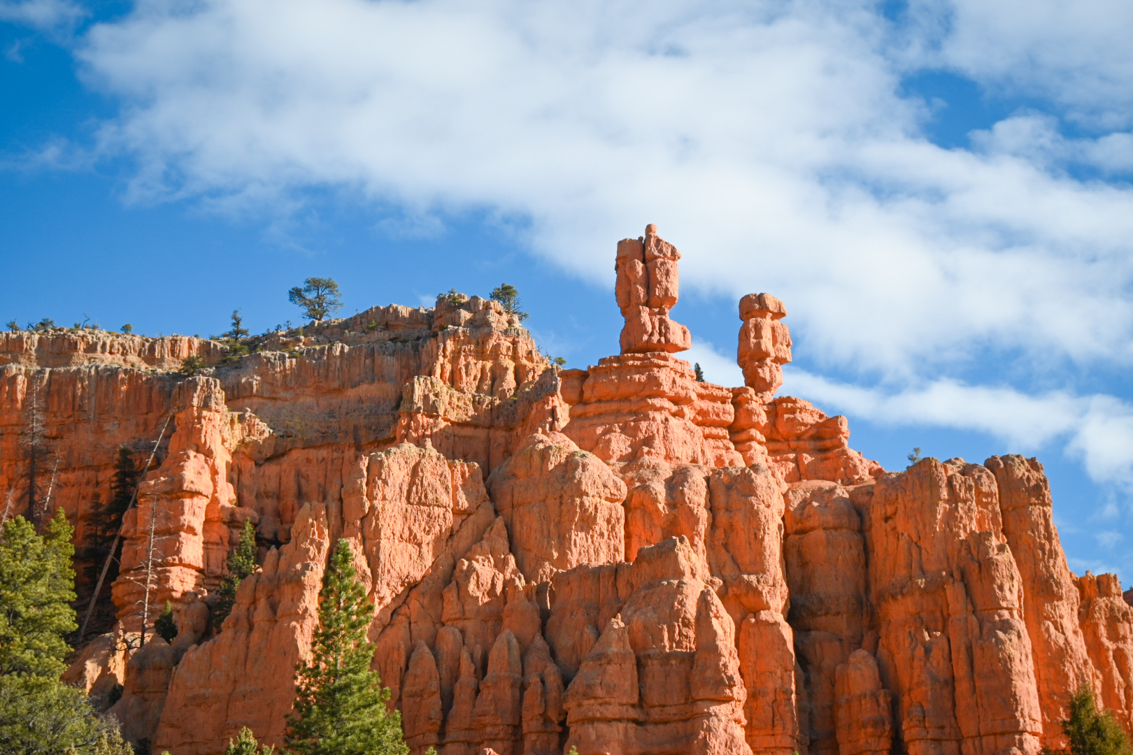Bryce Canyon is known for crimson-colored hoodoos, which are spire-shaped rock formations.