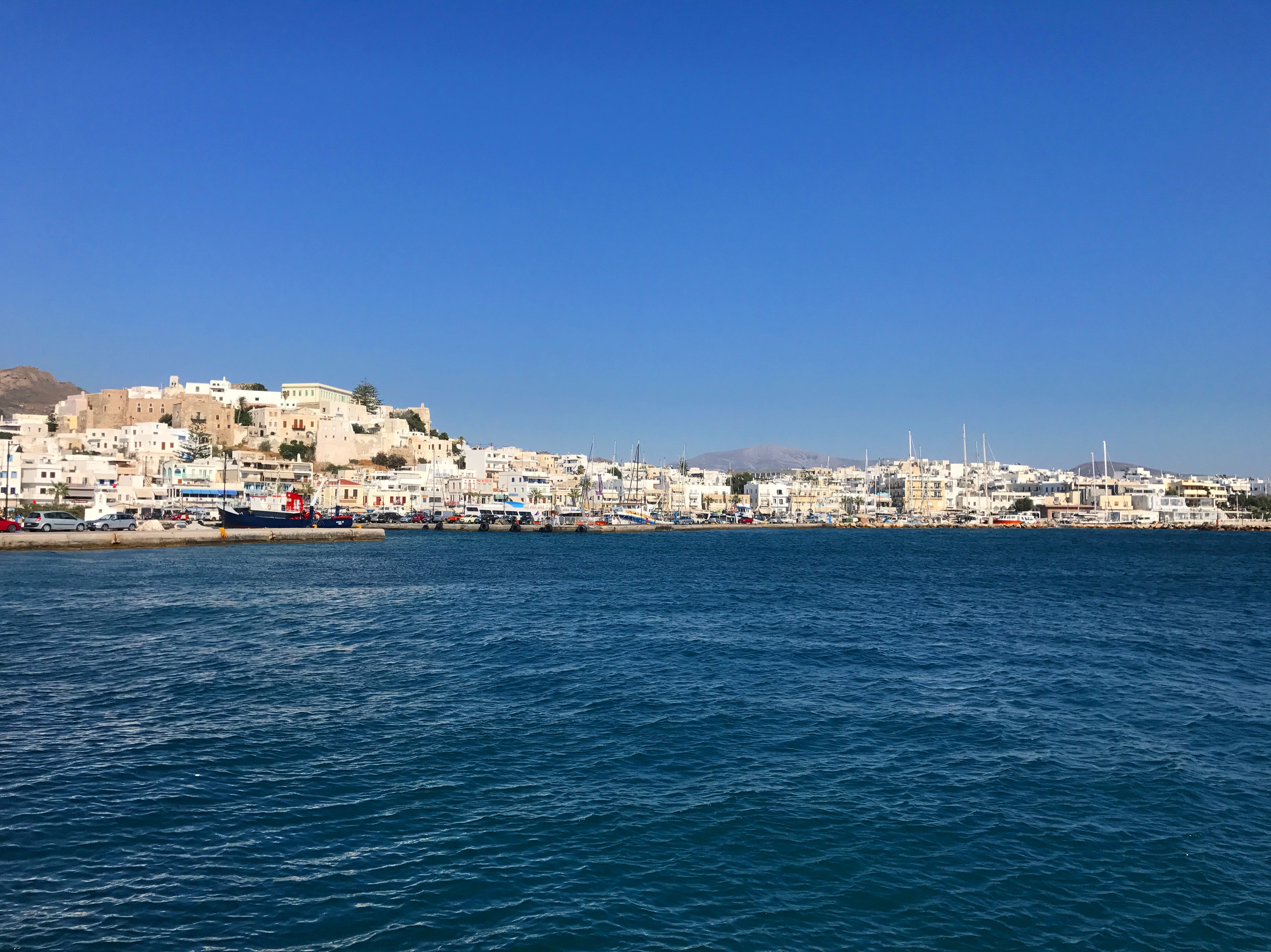 View of the ocean and coastal city with white and light-colored buildings