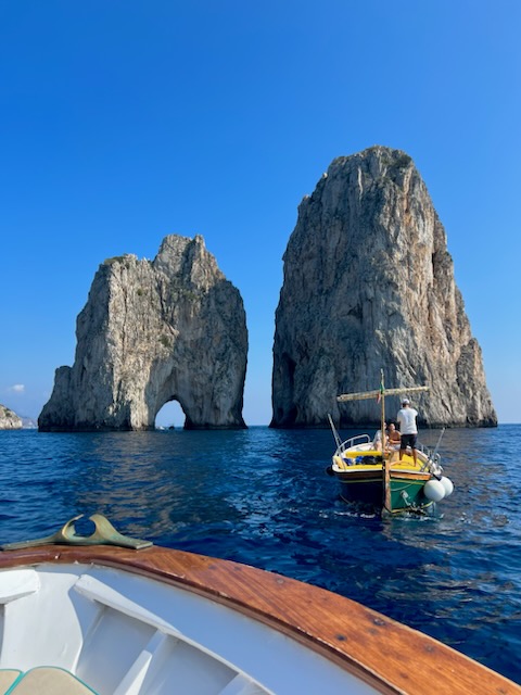 View from the boat of ocean and two large rock structures