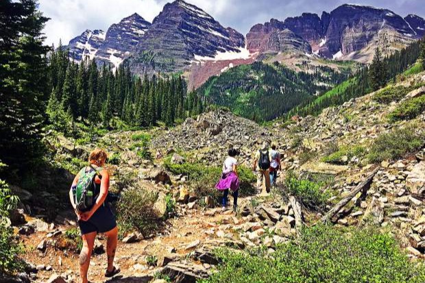 A group of people hiking a mountain during the daytime