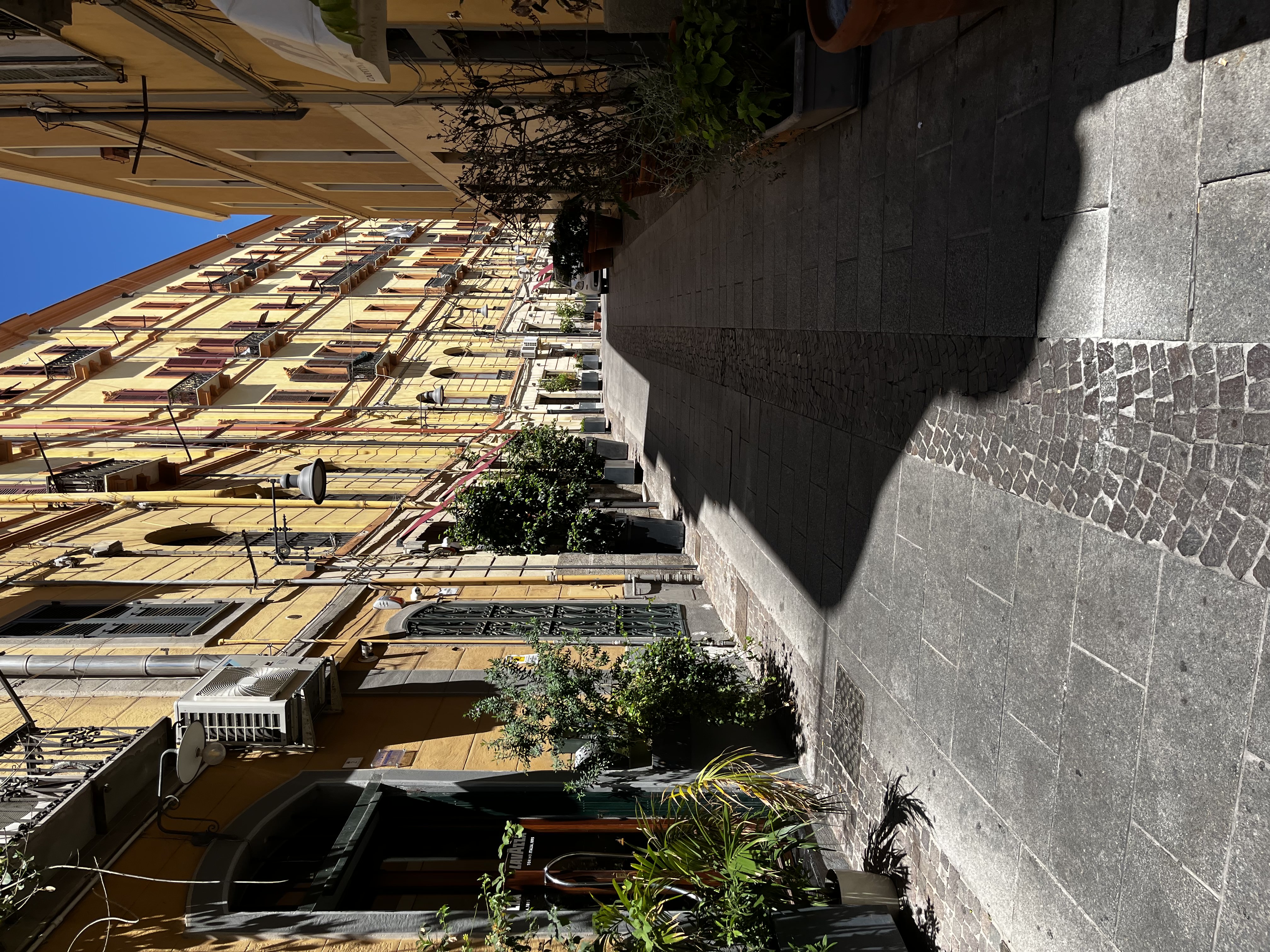 View of a narrow street with yellow buildings