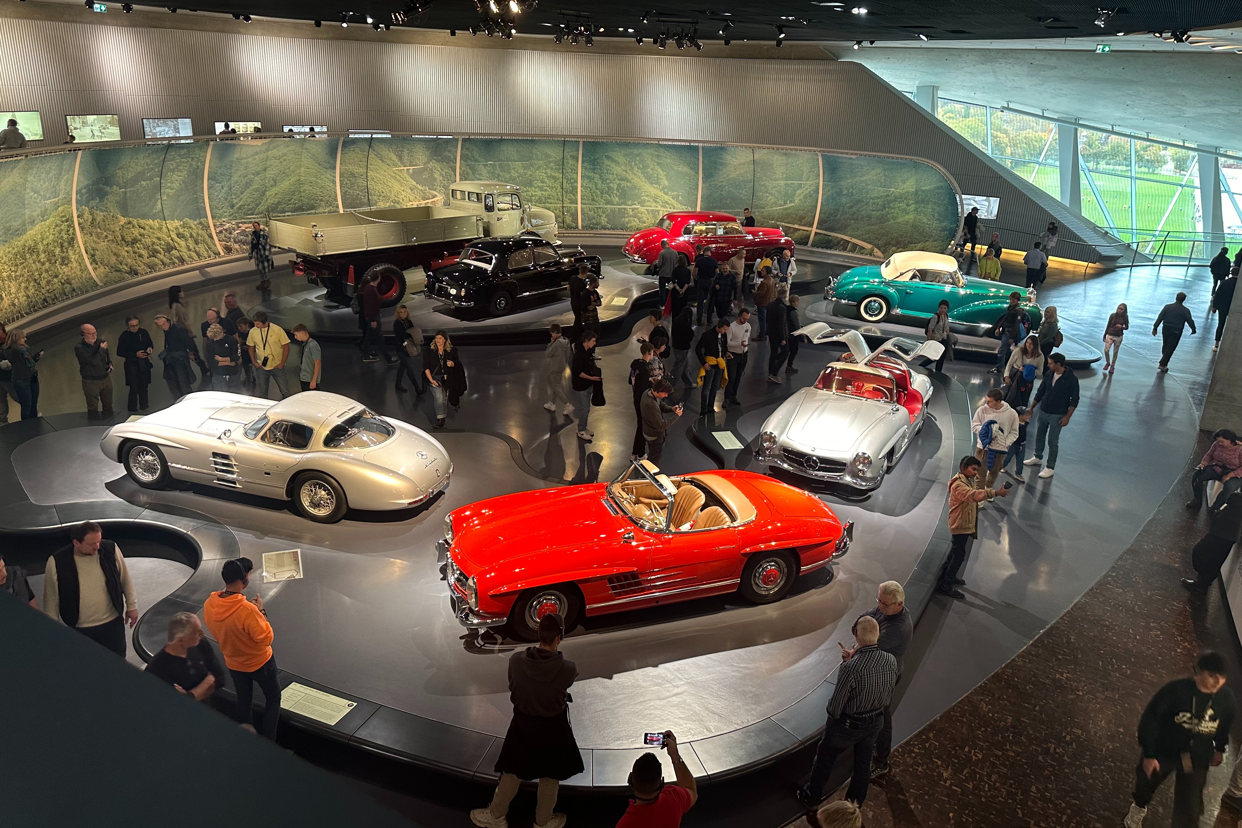 An indoor show room of vintage cars