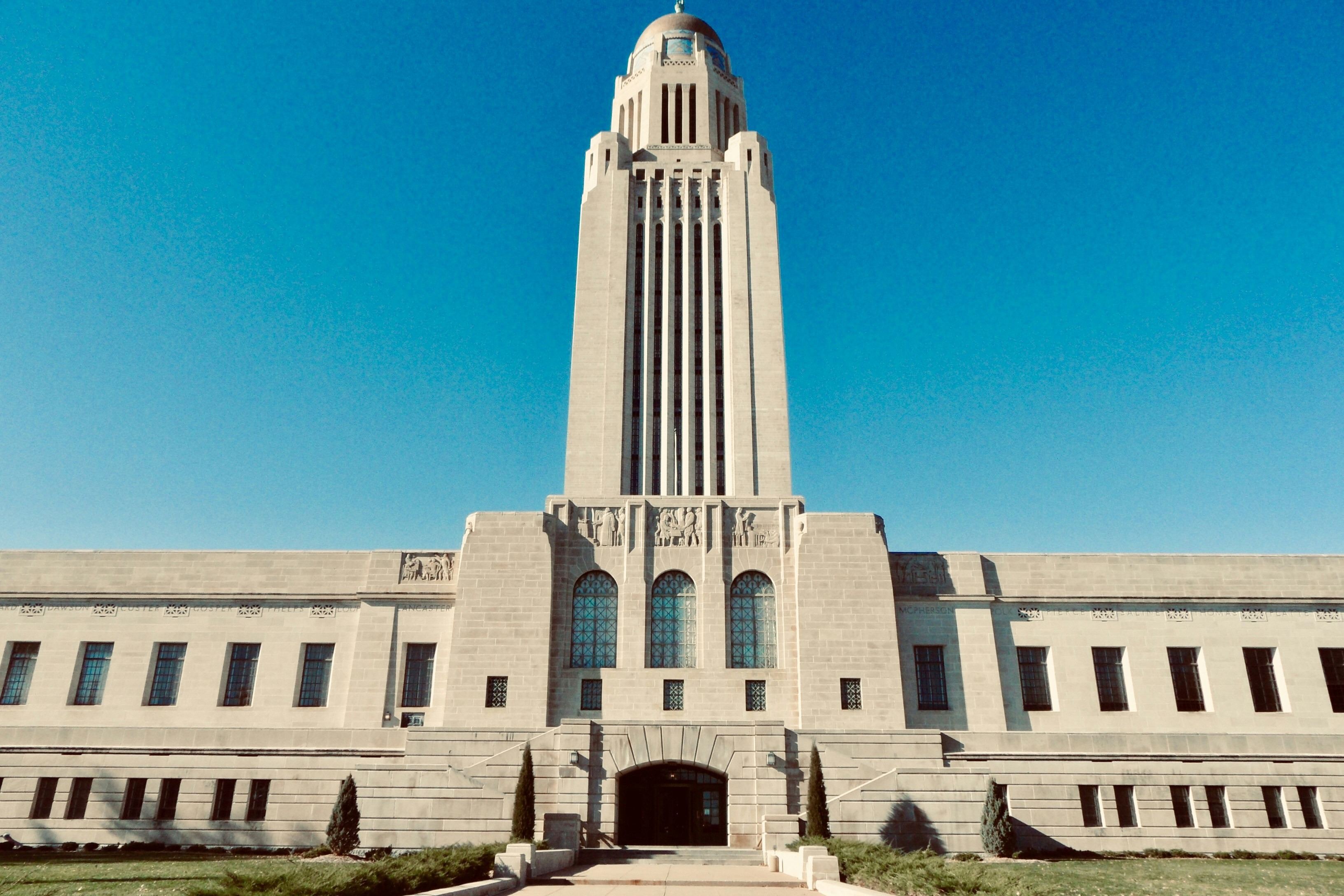A white concrete building called Nebraska State Capitol during daytime.