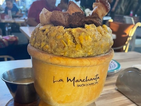 A traditional dish inside of a bowl saying "La Marchanta"