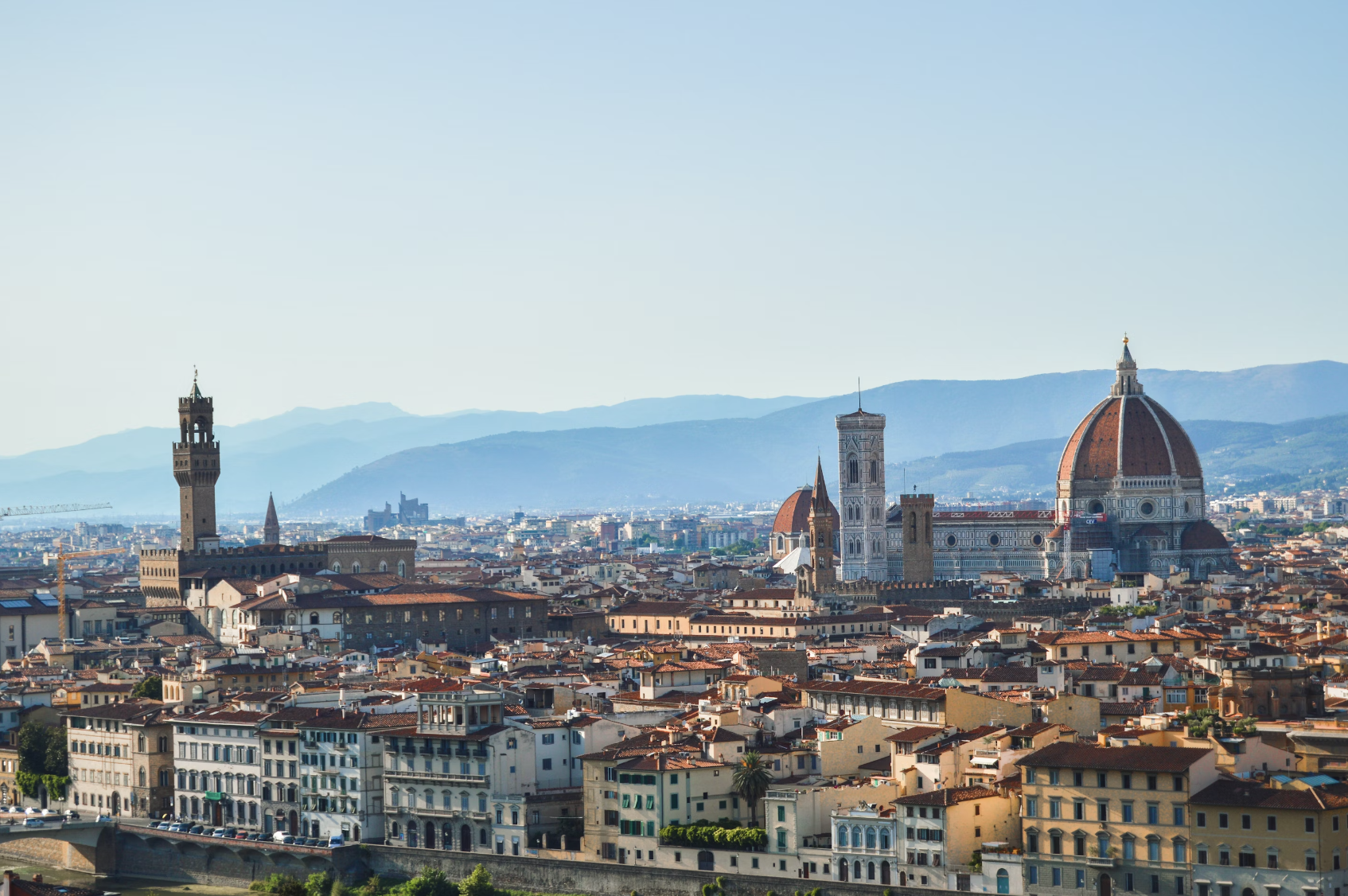 Aerial view of Florence with mountains fading in the distance.