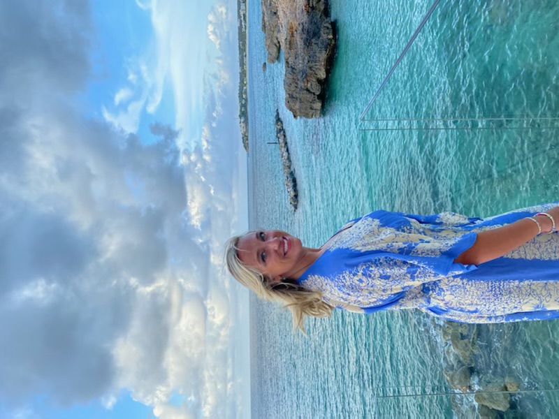 Picture of Mckenzie in blue and white dress with beautiful sea view