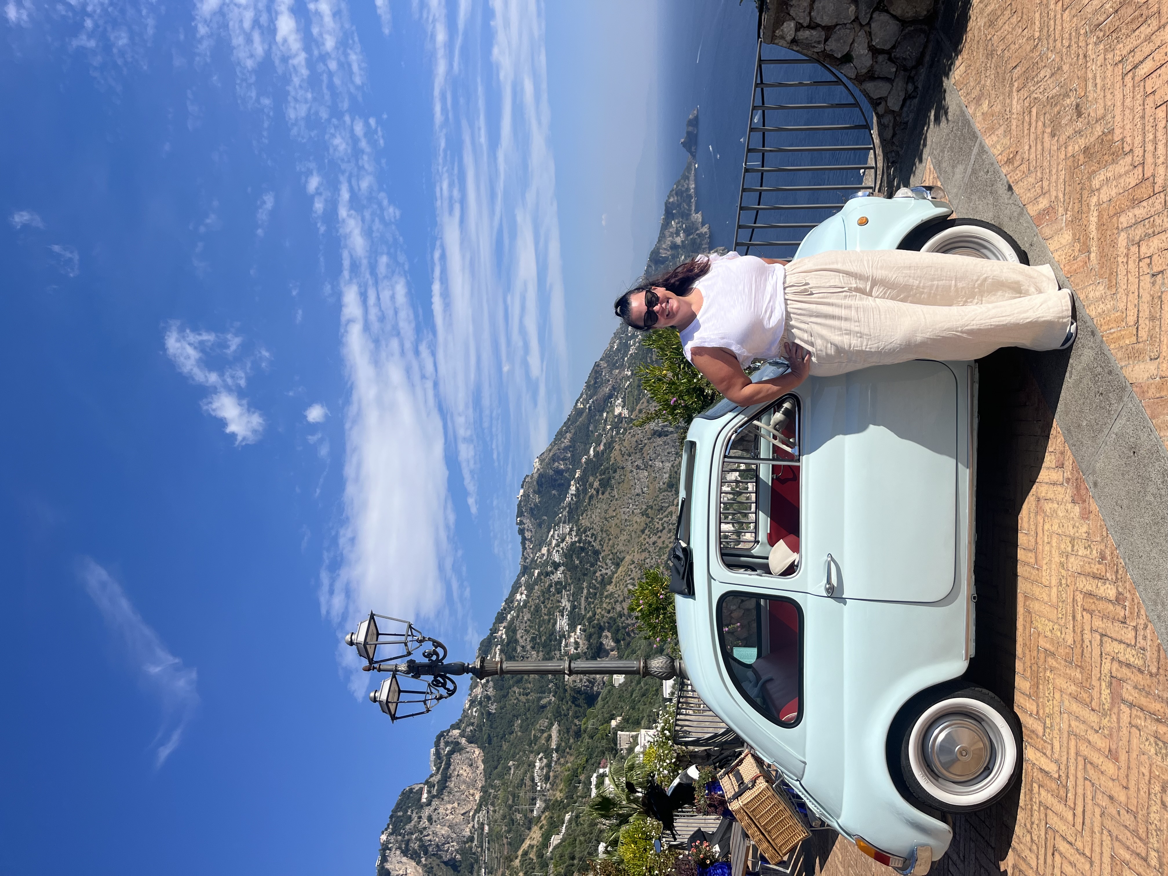 Posing for a picture with a mini car