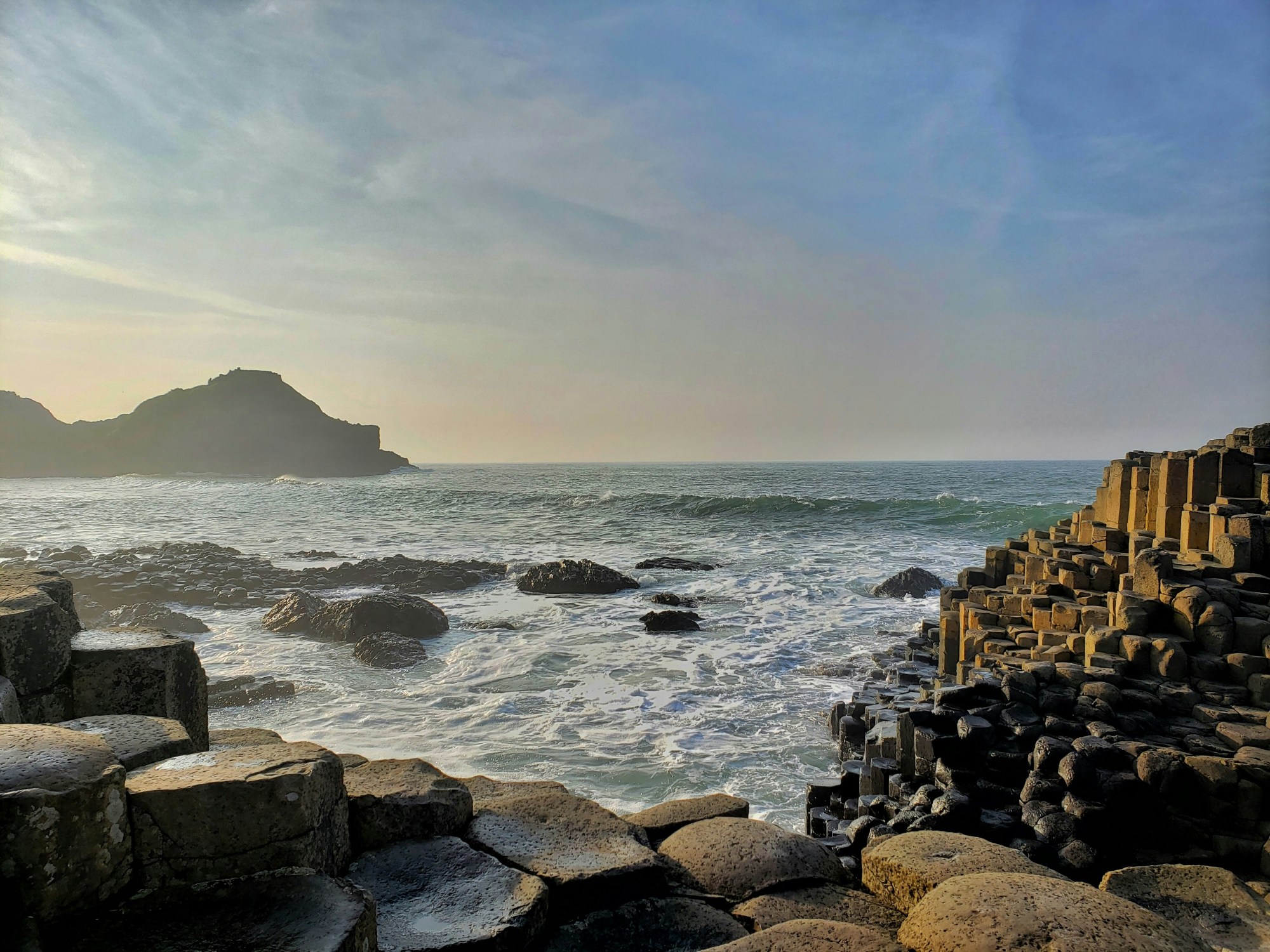 Brown rocks on sea shore during daytime.