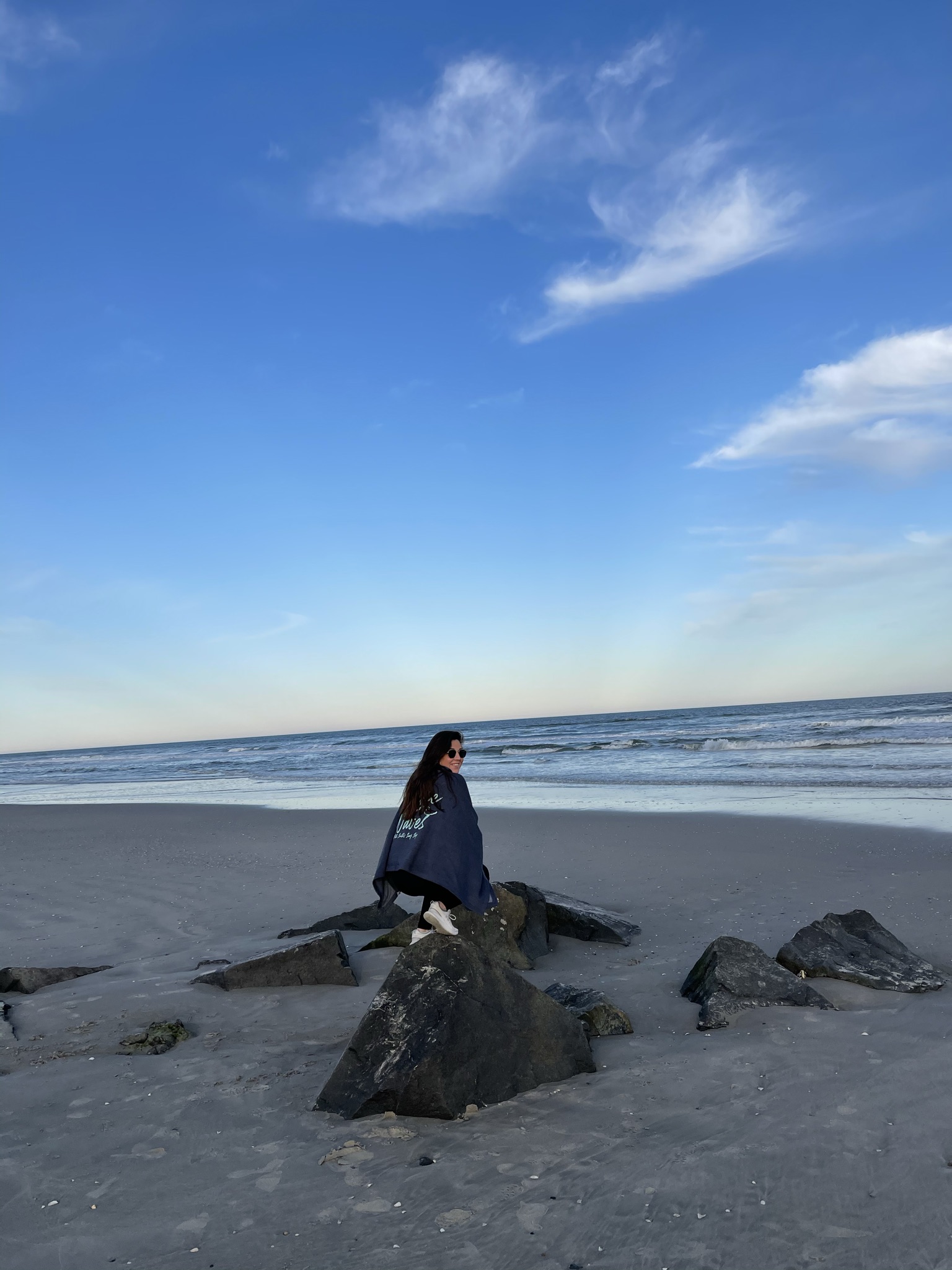 Picture of Carolyn siiting on rock on beach