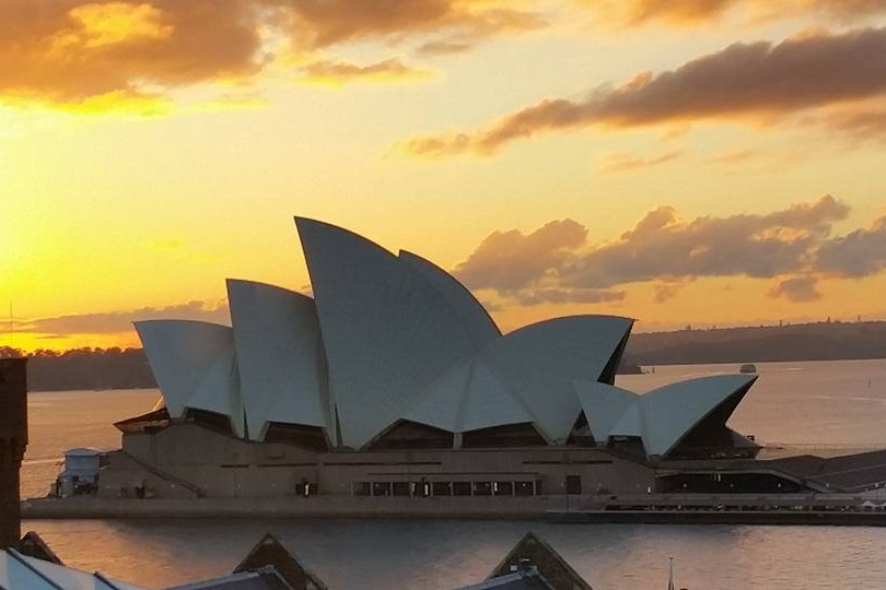 Sunset view of the iconic multi-venue performing arts center Sydney Opera House.