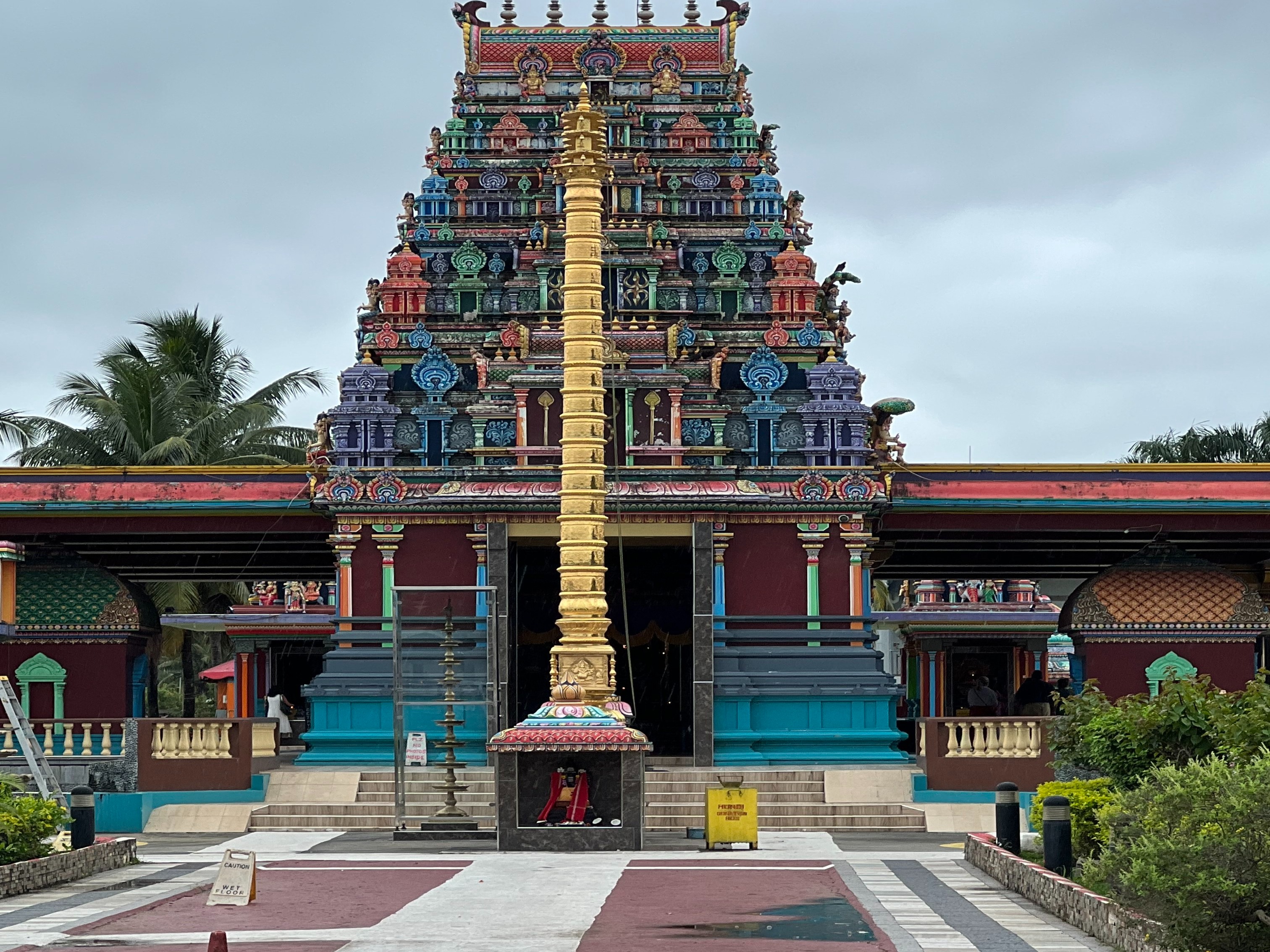 A far view of a multi-colored temple in the daytime.