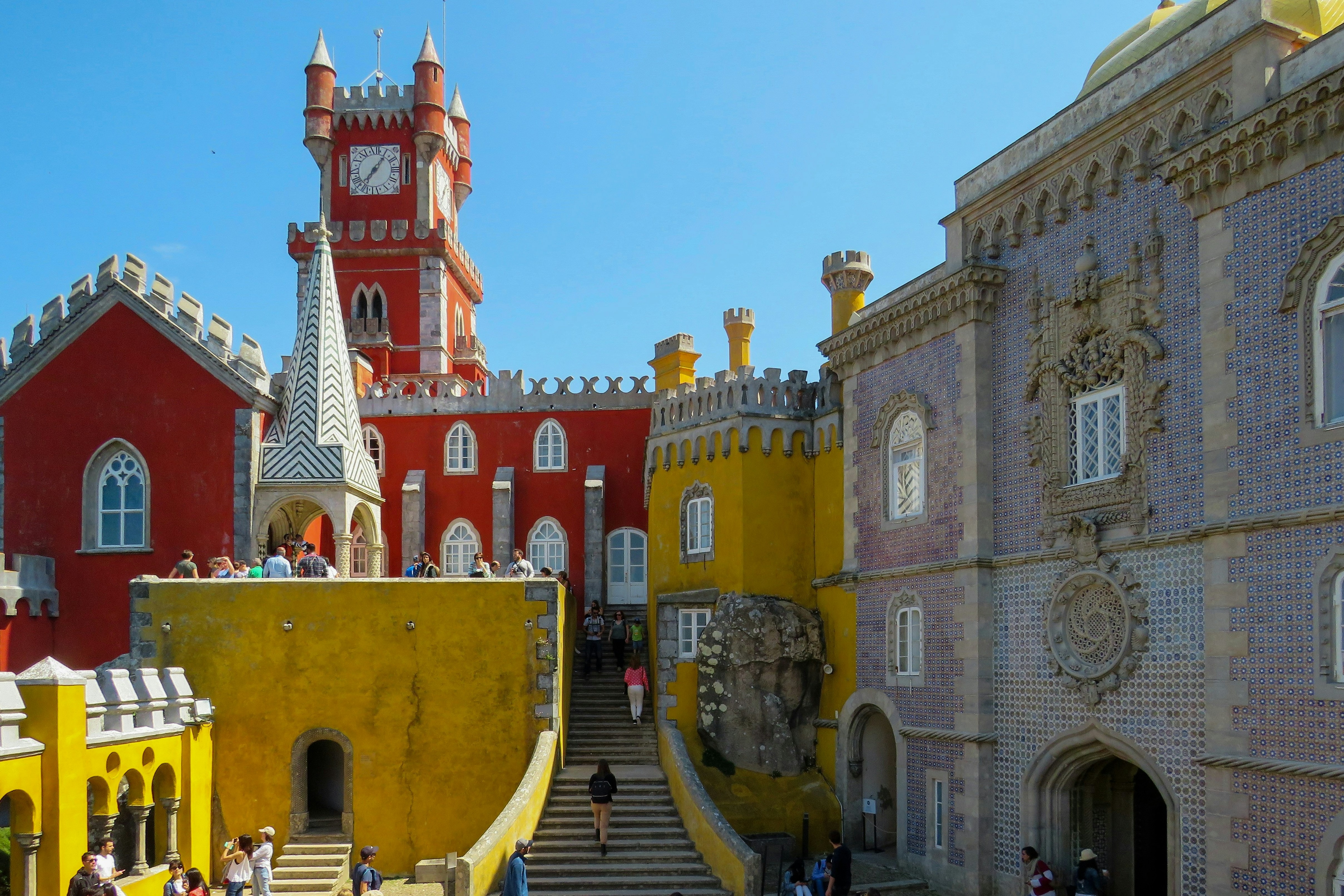 A picture of colorful beautiful buildings and people walking up the stairs.